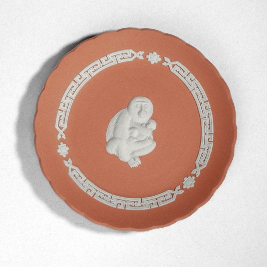 Wedgwood Jasper Plate Year Tray Monkey 2004: Wedgwood jasperware Eto Monkey Zodiac dish in terracotta with white decorations. Gold "YEAR TRAY MONKEY 2004" to back along with stamped mark. Excellent condition. 5" dia. The Myra O. Karp Collection.