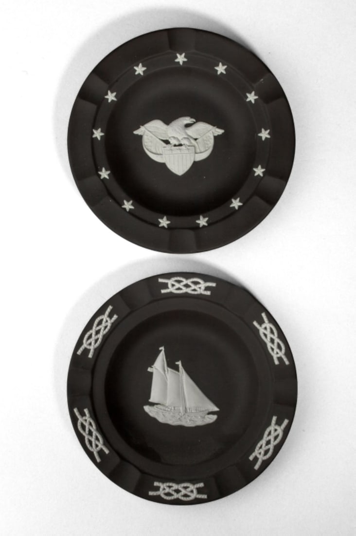 Wedgwood Jasperware Ashtrays: Two Wedgwood black jasperware ashtrays; one with sail boat and one with American eagle (small rim scuff). Both very good condition and appear unused. 6.75" dia. The Myra O. Karp Collection.