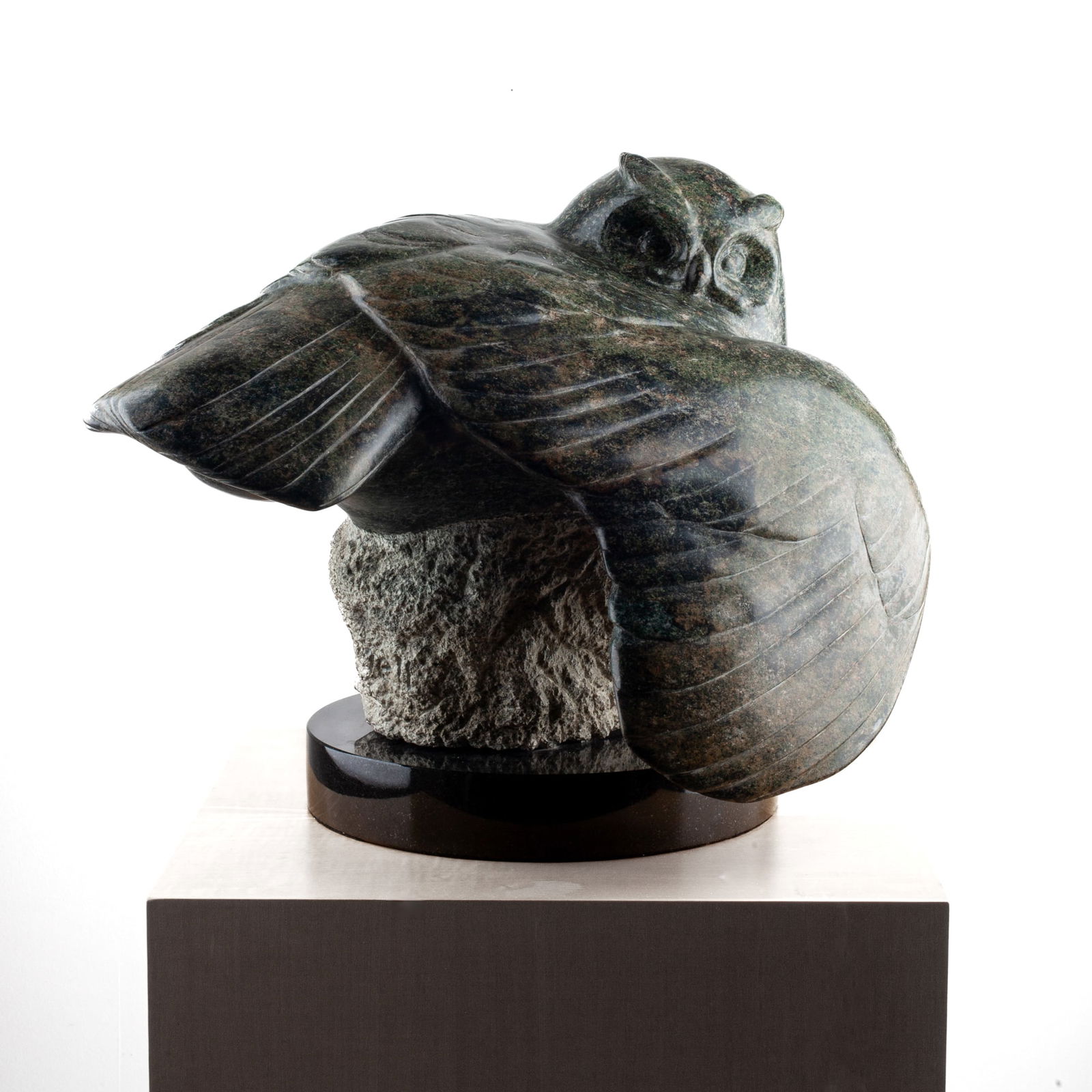 Tony Angell (WA) "Eagle Owl" Serpentinite Sculpture, 1994: Tony Angell (b.1940 Washington) "Eagle Owl" Carved Serpentinite Sculpture, 1994. Signed on unpolished area of base by claws. Measures 17 x 22 x 19" and sits on top of 12" polished black marble base. E