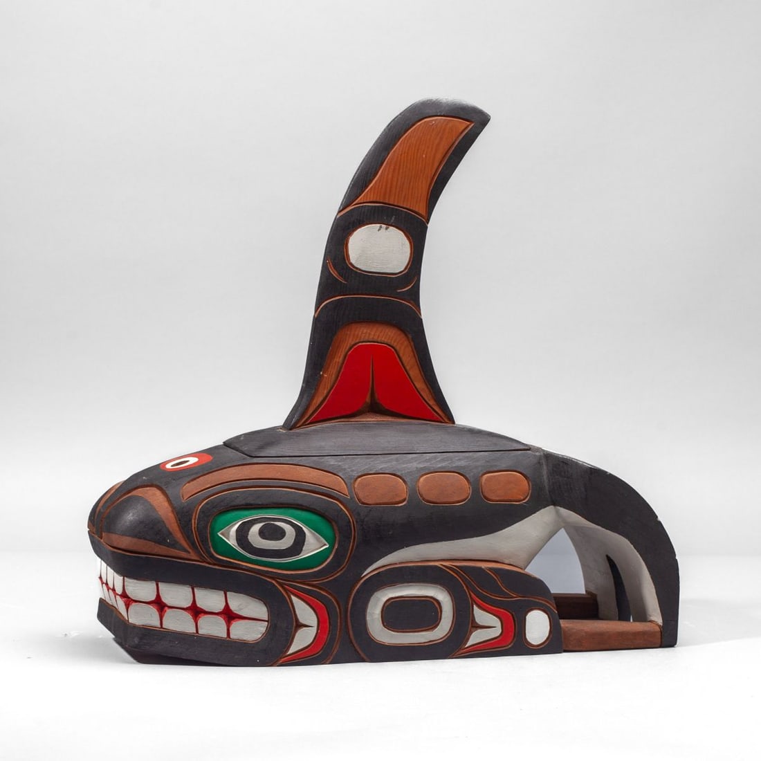 Gary Rice Northwest Coast Carved Cedar Whale: Gary Rice (b. 1935 Kwakiutl) carved and polychromed cedar wood whale carving. Carved in traditional Coast Salish style with figural motif to tailfin; tall dorsal fin removeable from base, revealing a 