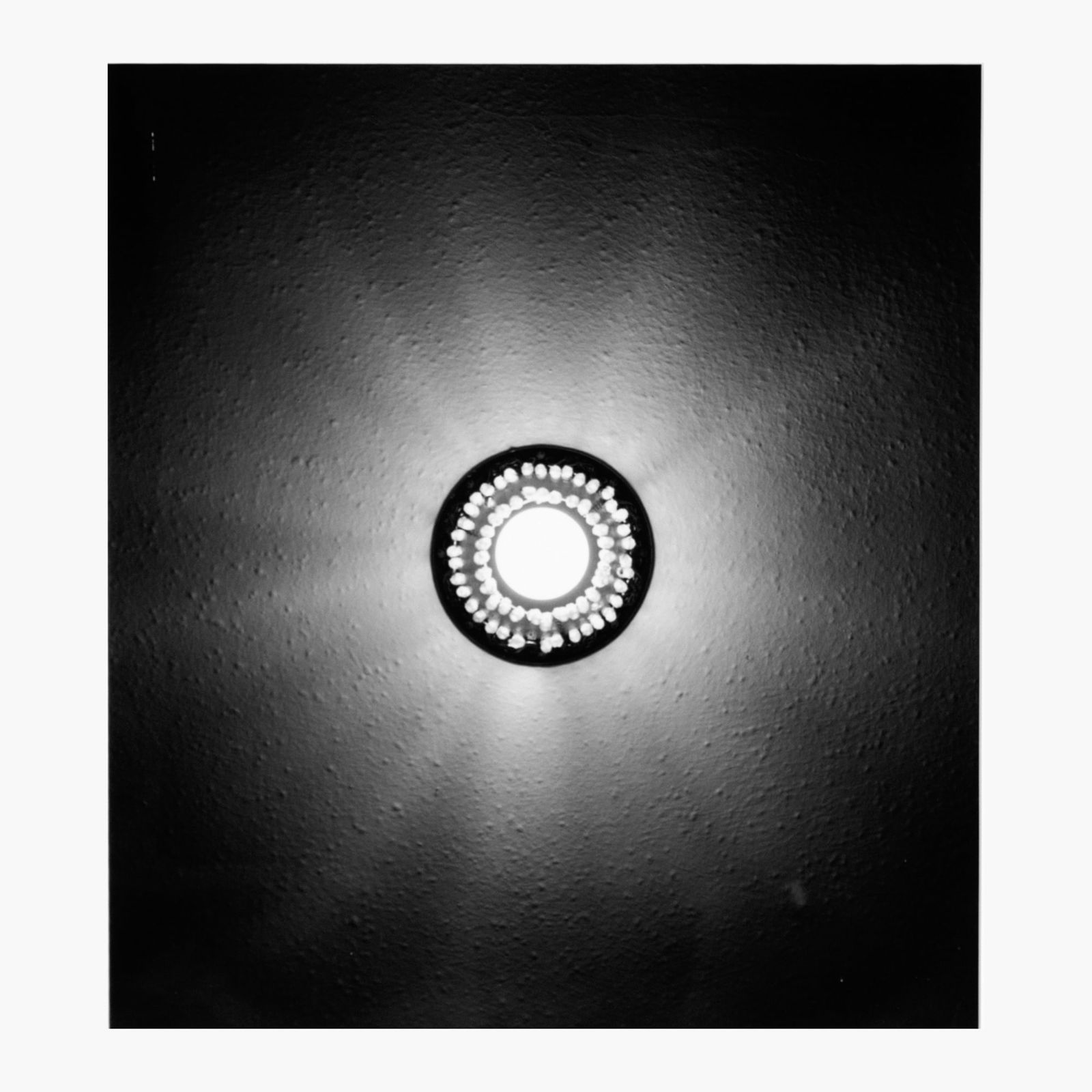 Gay Outlaw "Light Fixture (Eclipse)" Photograph: Gay Outlaw (b.1959 California) "Light Fixture (Eclipse)" Gelatin Silver Photograph, 1992. Edition 3/3. Image measures 19.5x17.5", matted and framed in black wood frame with overall size 25.5x23". Some