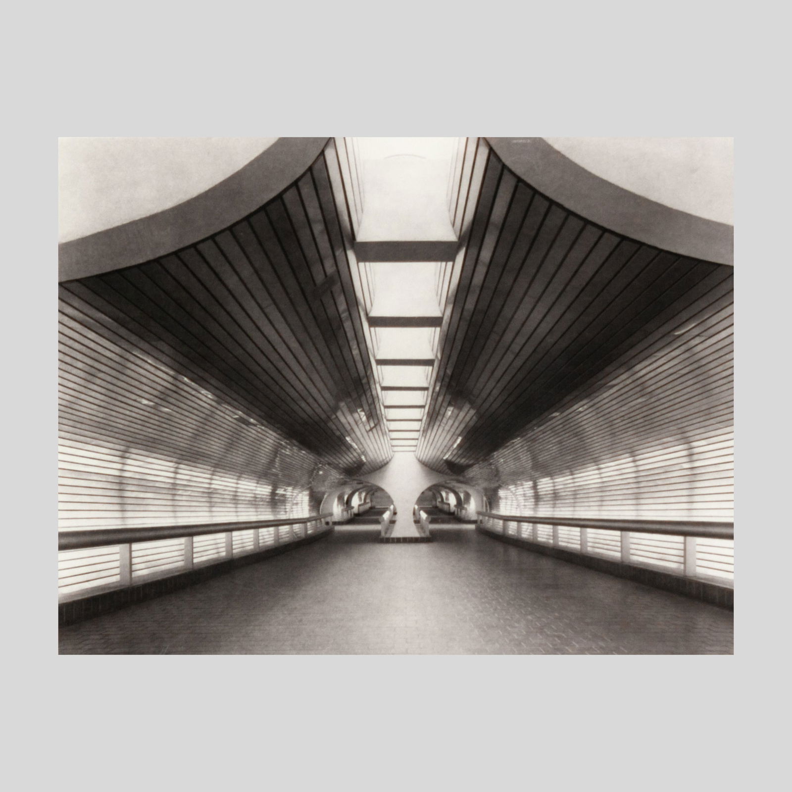 Tillman Crane Tunnel to the Trains Platinum Print: Tillman Crane (b.1955 Maine) "Tunnel to the Trains" Platinum / Palladium Print, 1990. Edition 6/25. Pencil signed at lower right. Photograph measures 14x18.5", professionally framed in dark stained wo