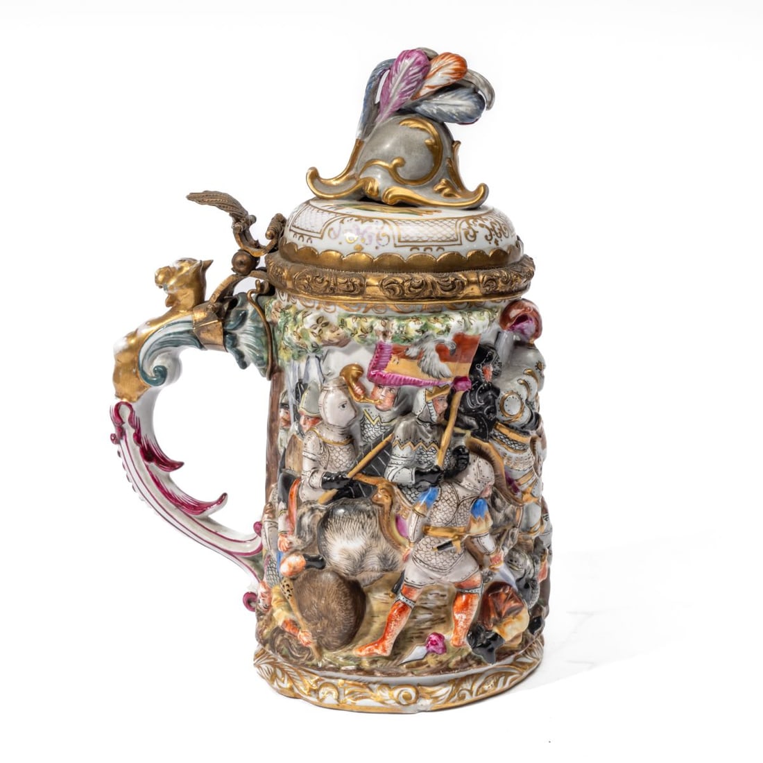 Capodimonte Style Medieval Knight Beer Stein: Antique Capodimonte style (with applied blue Meissen style mark to bottom) porcelain beer stein / tankard. Hand painted / gilded molded and raised Medieval knight battle scene with horses. Hinged lid