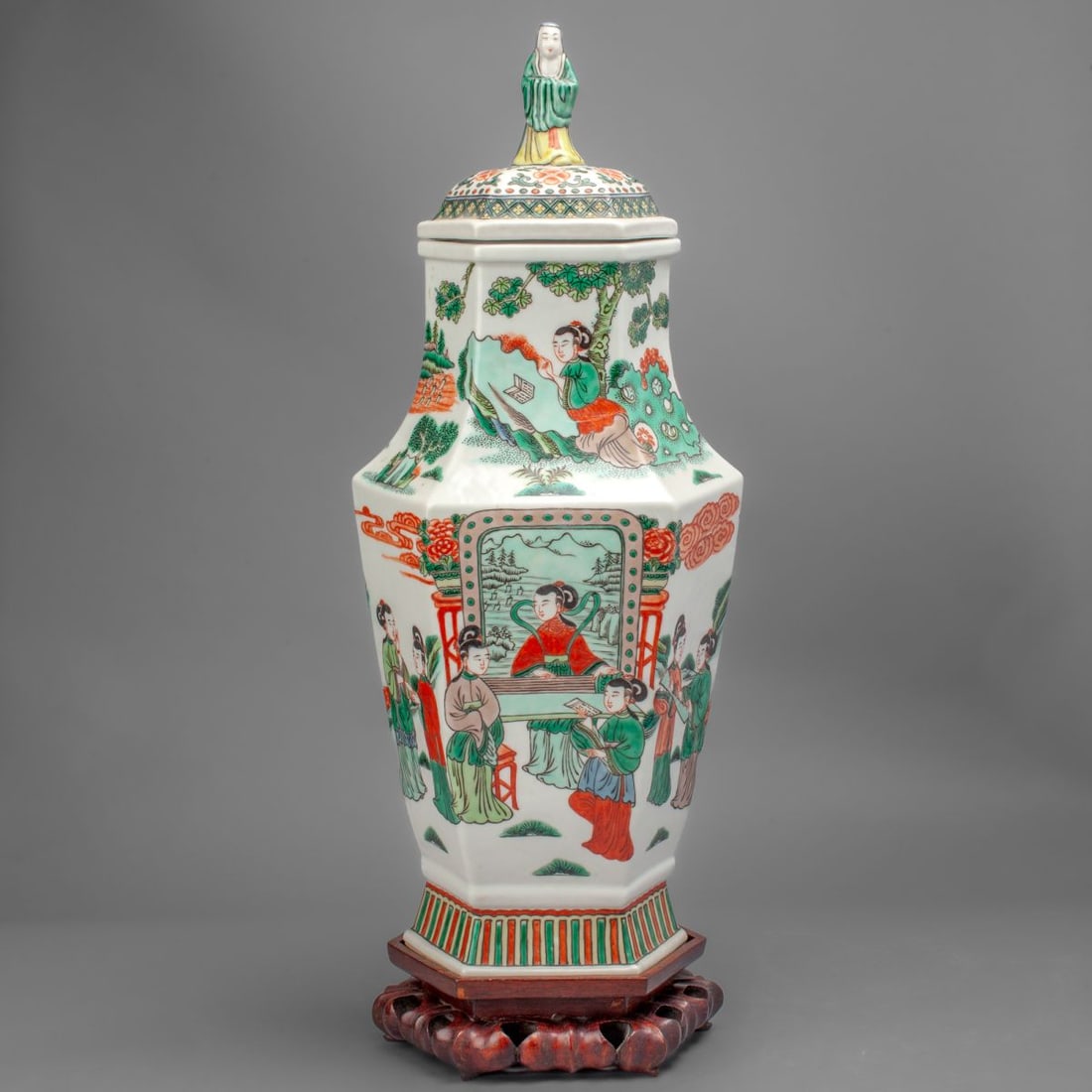 Chinese Famille Verte Porcelain Hexagonal Vase: Chinese Famille Verte Porcelain Hexagonal Vase. The slab-form hexagonal body with maidens enjoying books and the sounds of the zither in a garden. In Famille Verte enamels. With figural cover. Six-cha