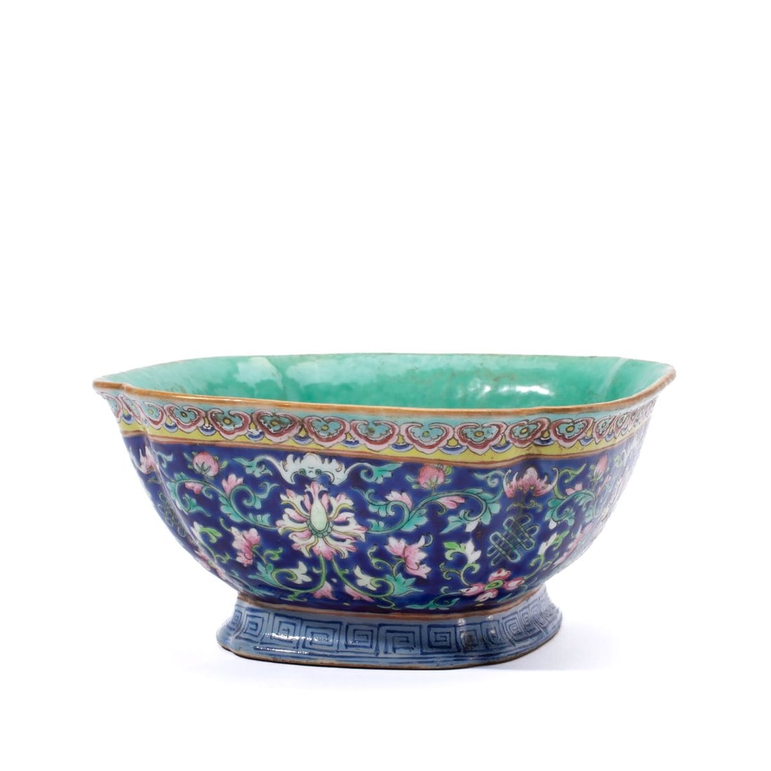Chinese Daoguang Mark Bat & Lotus Porcelain Bowl: Chinese enameled porcelain bowl of tall quatrelobed form with enameled lotus, flowerheads and bats over navy ground below ruyi head border and sitting on a tall foot with keyed pattern. 19th century. 