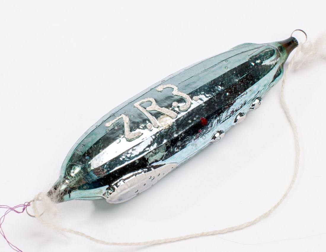 Antique Glass Zeppelin ZR3 Christmas Ornament: Antique German glass Zeppelin ZR3 Los Angeles Christmas tree ornament. Pale blue with white painted details. Expected signs of age, wear, etc. No apparent breaks, cracks, chips. 5.25" L.