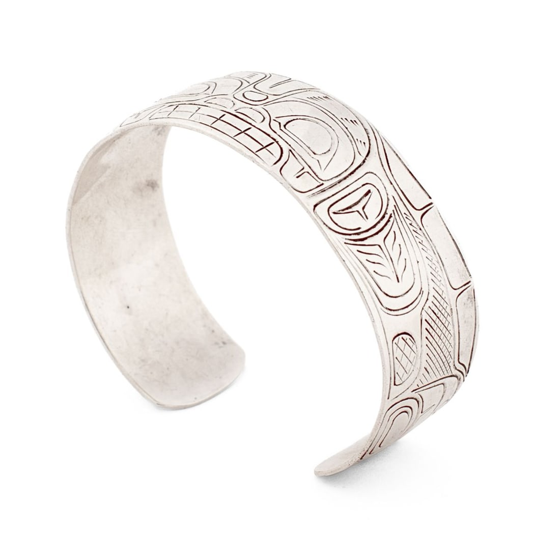 Jim Long Native Artist Whale Silver Bracelet: Unmarked silver bracelet by native artist Jim Long. Chased stylized whale design. "JL" stamped mark to interior band. Slight warp to bracelet at one end; otherwise in good condition. Opening 1"; 2.5" 