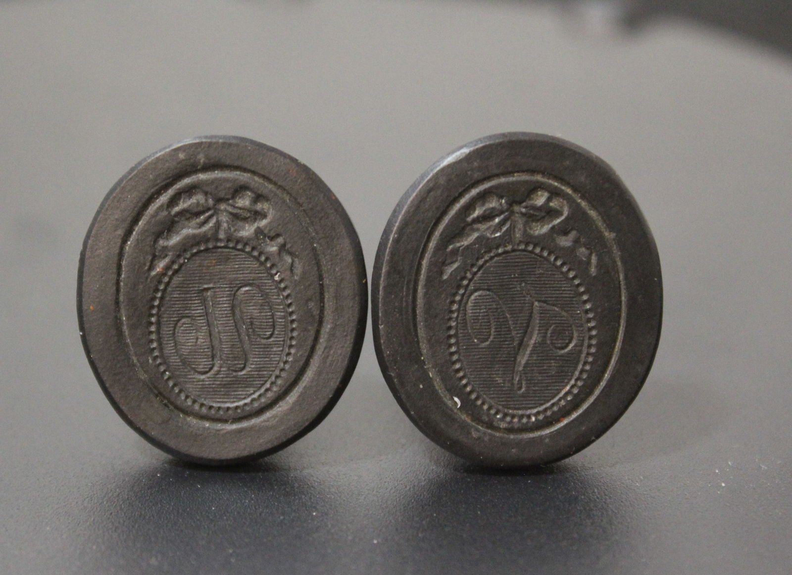 2 Wedgwood Black Basalt Intaglio Seals: Two 18th century Wedgwood black basalt intaglio seals. Both with tall fluted stems with monogram below ribbon. Unmarked. Both in very good condition. 0.75" H x 0.75" D approx. each. The Myra O. Karp W