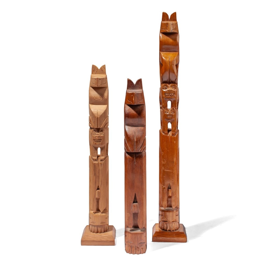 3 Ron Inung Felix Inuit NW Coast Totem Poles: Three carved wood totem poles by Ron Inung Felix (Tuktoyaktuk, Canada). (1): Thunderbird over two bears and whale. Signed at reverse. Some surface wear; in good condition overall. 17" H. (2): Thunderb
