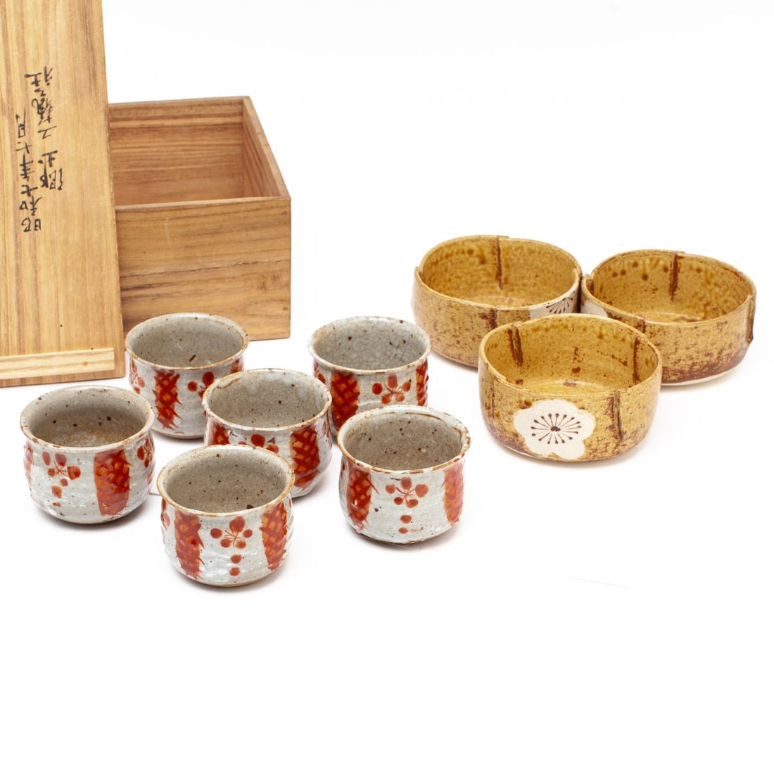 2 Sets of Bowls & Cups by Fuji Tatsukichi: Japanese ceramic sets designed by Fuji Tatsukichi (1884 - 1961 Japan). (1): Set of six stoneware cups, each with slightly countersunk base, body with horizontal ribbing and everted rim, covered with g