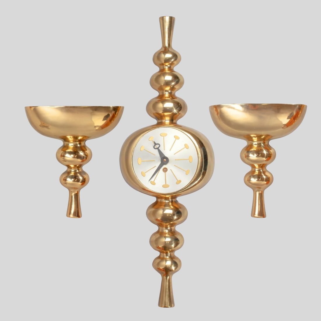 Mid Century Modern Wall Clock & Sconce Set: Vintage midcentury 3-piece wall clock and sconce set in heavy cast metal with bright brass plating. George Nelson style aluminum clock face. Quartz battery movement marked "MAYFAIR"; currently running