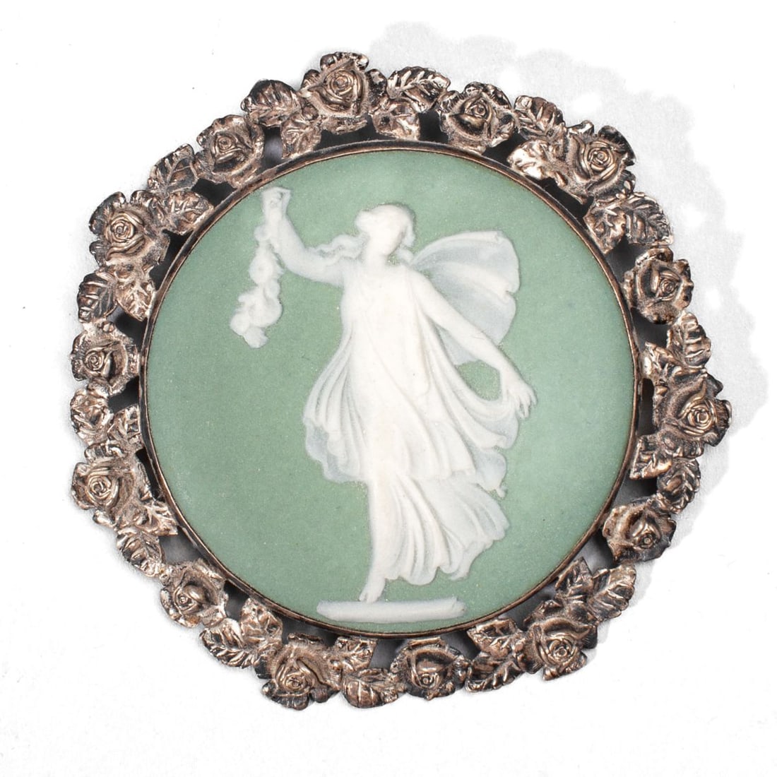 Wedgwood Green Jasper & Sterling Silver Brooch: Brooch comprised of early 20th century Wedgwood jasperware roundel with classical maiden carrying floral garland set into sterling silver openwork rose flower mounting. Impressed "WEDGWOOD" and "ENGLA