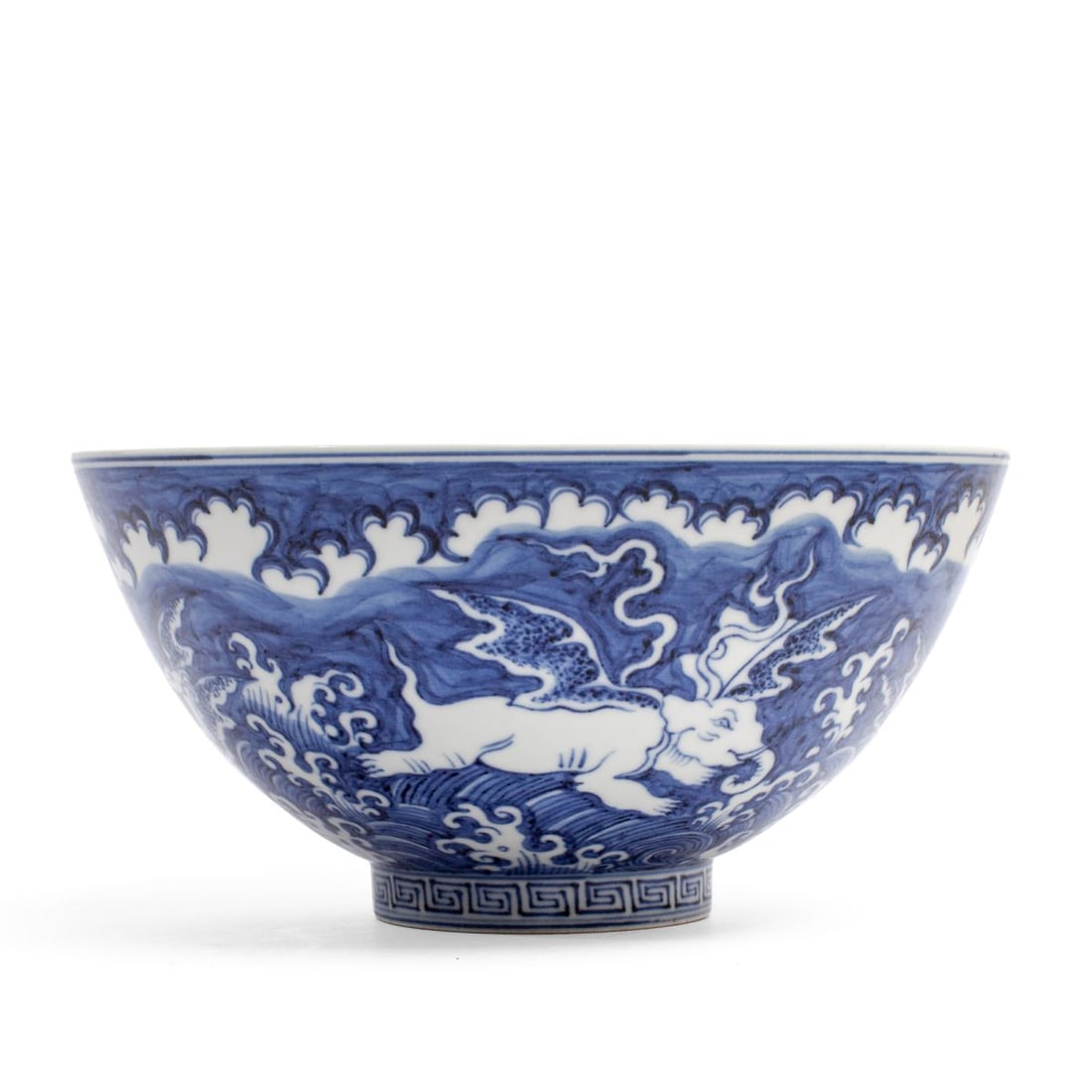 Chinese Porcelain "Winged Beasts" Bowl Xuande Mark: Chinese porcelain bowl of wide flaring form on tall foot with painted winged beasts over rolling waves in underglaze blue, the interior roundel having winged elephant over the same. Apocryphal six-cha