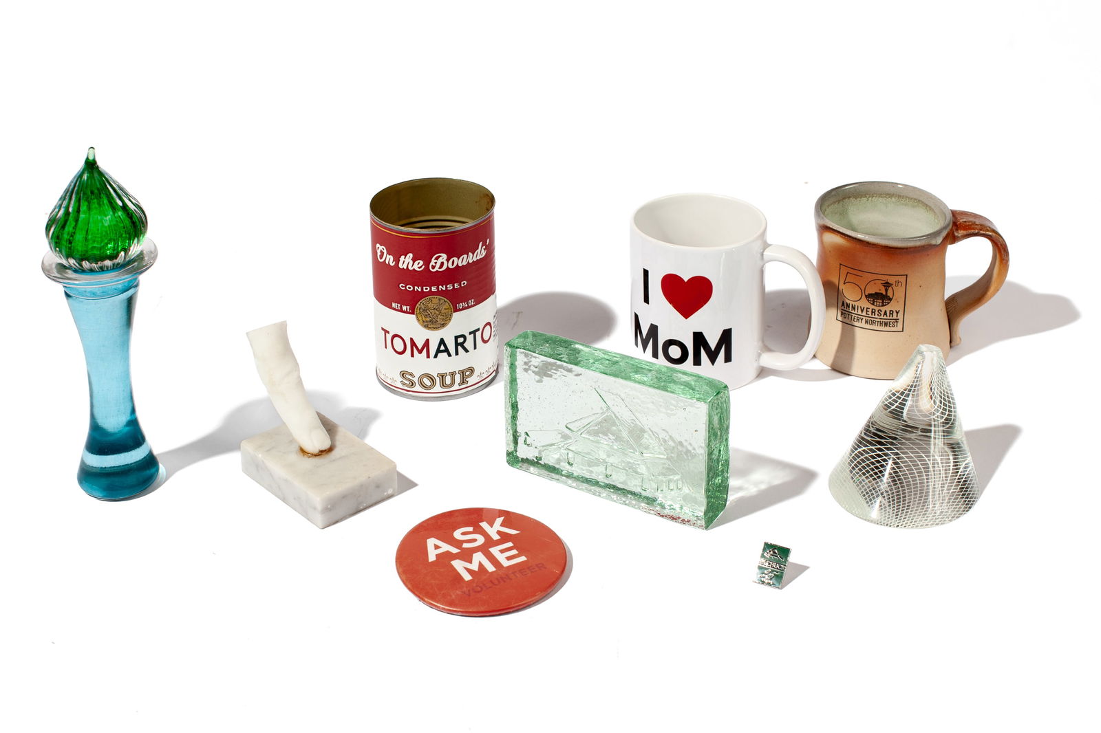 Group of Art & Culture Souvenirs: Group of Art & Culture Souvenirs. Includes (1) Pilchuck cast glass paperweight - 5x3x1" and Pilchuck 25th Anniversary Pin (2) Museum of Glass Paperweight - 3x4" (3) Museum of Museums coffee mug (4) Po