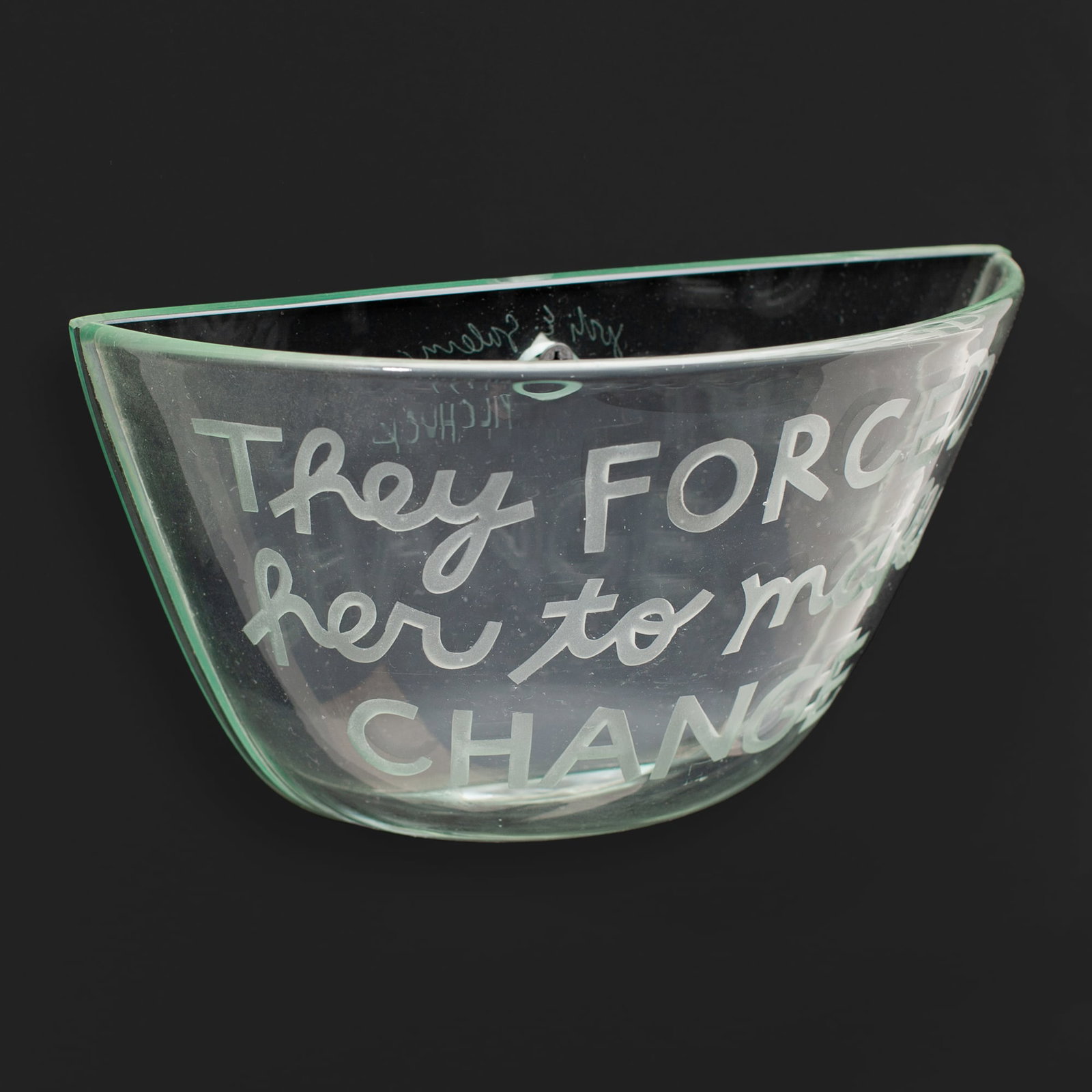 Jodi Salerno "They forced her to make change": Jodi Salerno (Massachusetts) "They forced her to make change" blown and etched glass wall pocket, 1994. Signed and dated on back with inscription "PILCHUCK". Measures 5.5x8.5x3.5". Excellent