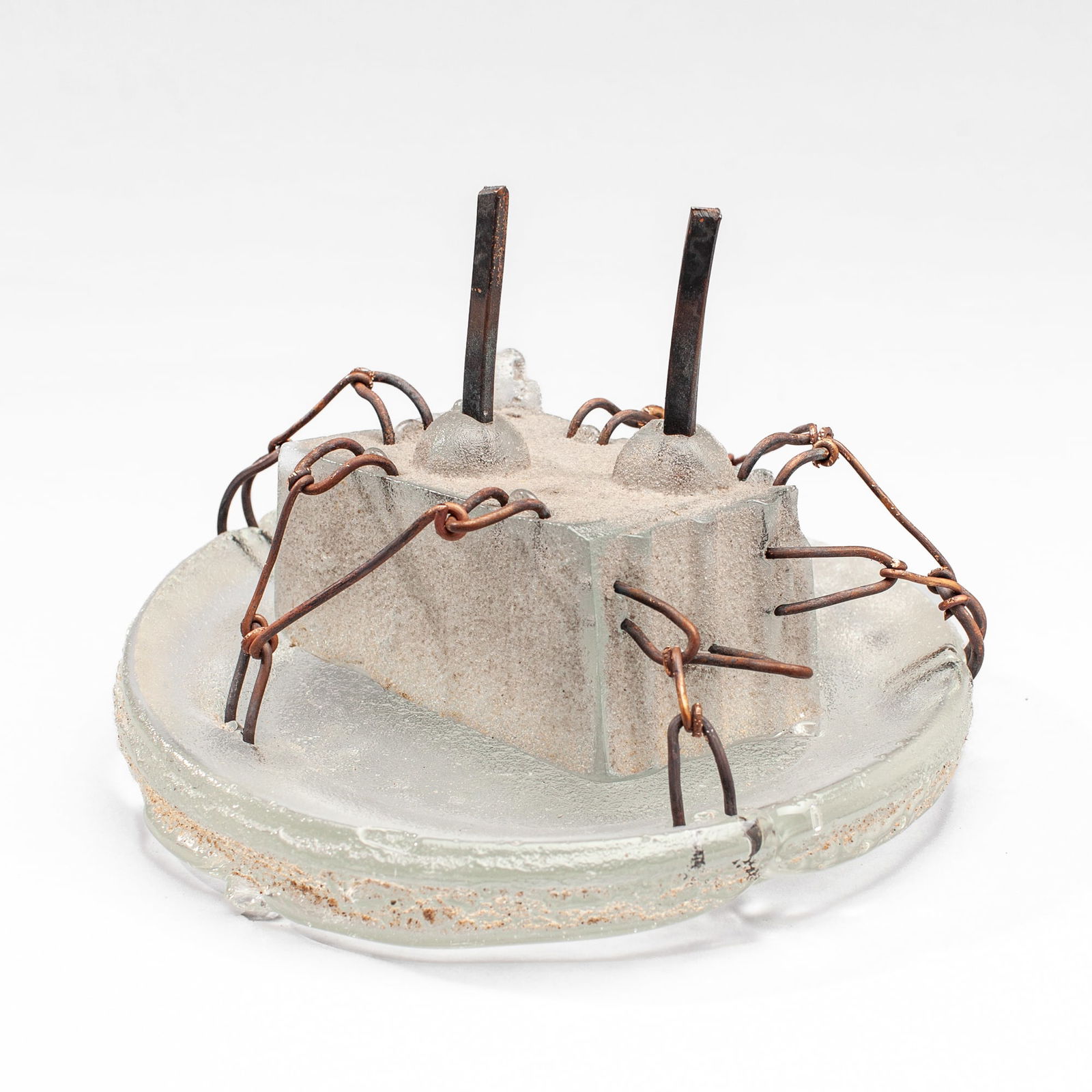 Hank Murta Adams "Birthday Cake , 2 Candles": Hank Murta Adams (b.1956 New Jersey) "Birthday Cake , 2 Candles" Mixed Media Glass Sculpture, 1998. Signed and dated on base. Cast glass, copper wire, and sand. Measures 5.5x8". Collection of Marge Le
