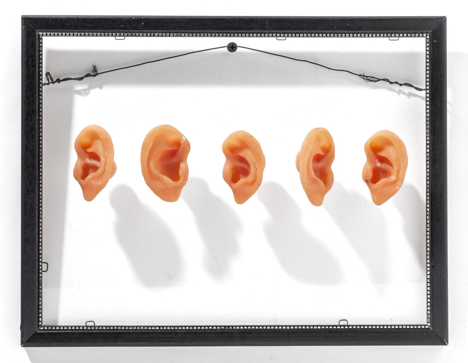 Lynne-Rachel Altman "The Wall Has Ears": Lynne-Rachel Altman (California) "The Wall Has Ears" Mixed Media Artwork, 1997. Signed and dated on frame at lower back. Beige cast glass on pane of glass in found wood frame. Measures 10x13x2". Excel