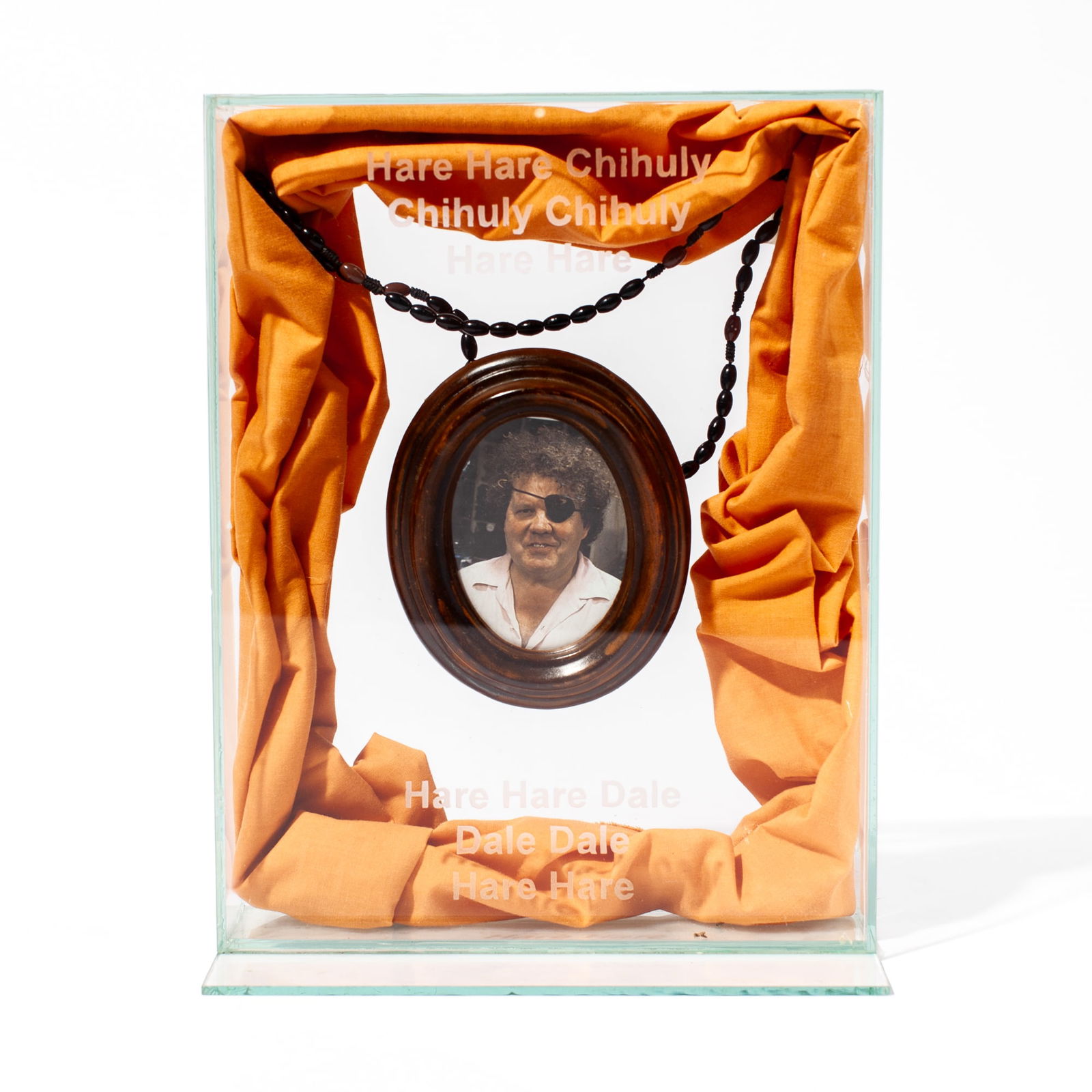 Dale Chihuly Shrine: Dale Chihuly Shrine. Mixed media glass box with photograph of Dale Chihuly at center and surrounded by peach colored cloth. Unsigned, possibly Richard Marquis or Therman Statom. Etched