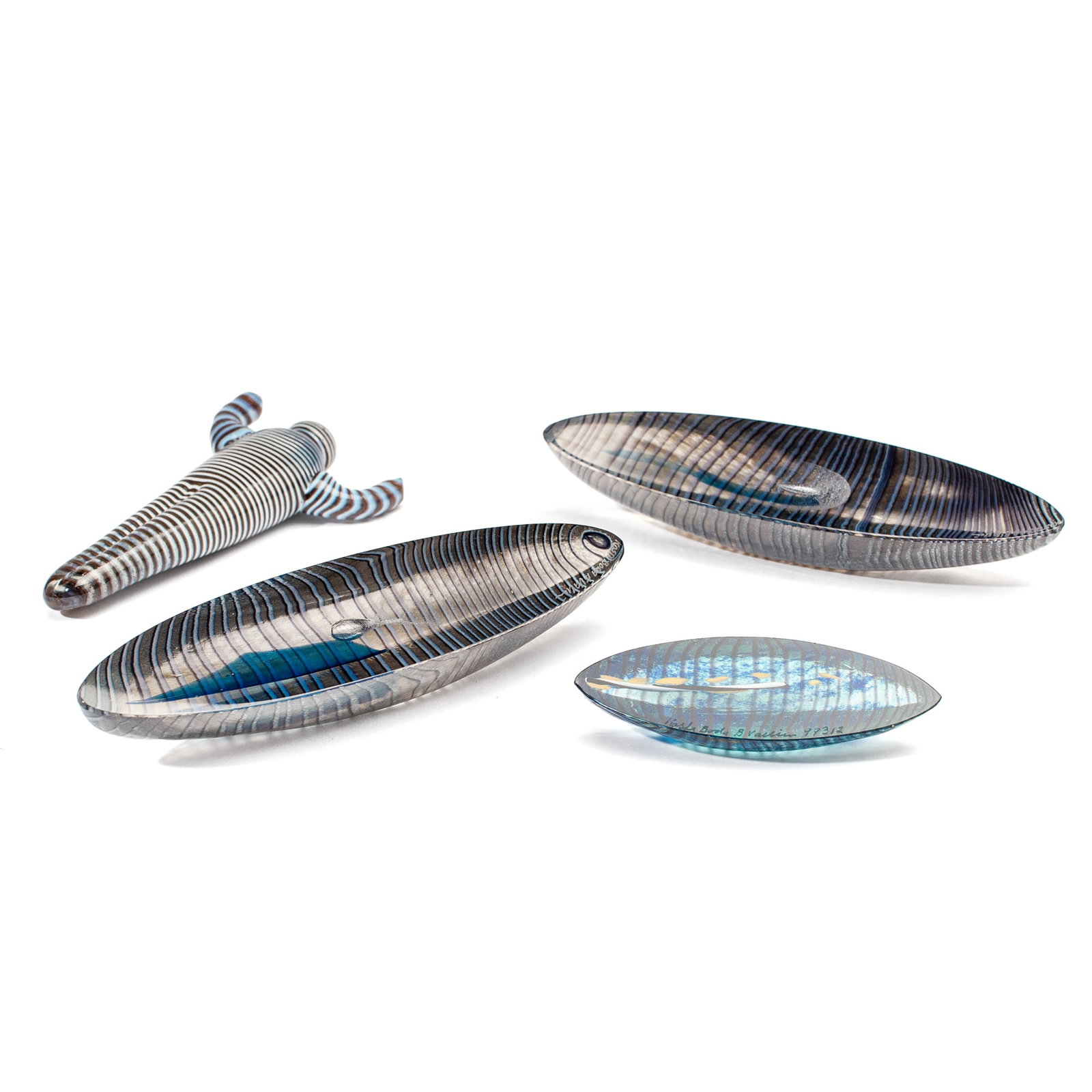 Group Bertil Vallien Small Glass Items: Group Bertil Vallien Glass Items. Includes (1) Striped Man Figure measuring 5x3", unsigned (2) Small cast boat measuring 4x1", signed Kosta Boda B Vallien 99312 along top edge (3&4) 2pc Kosta