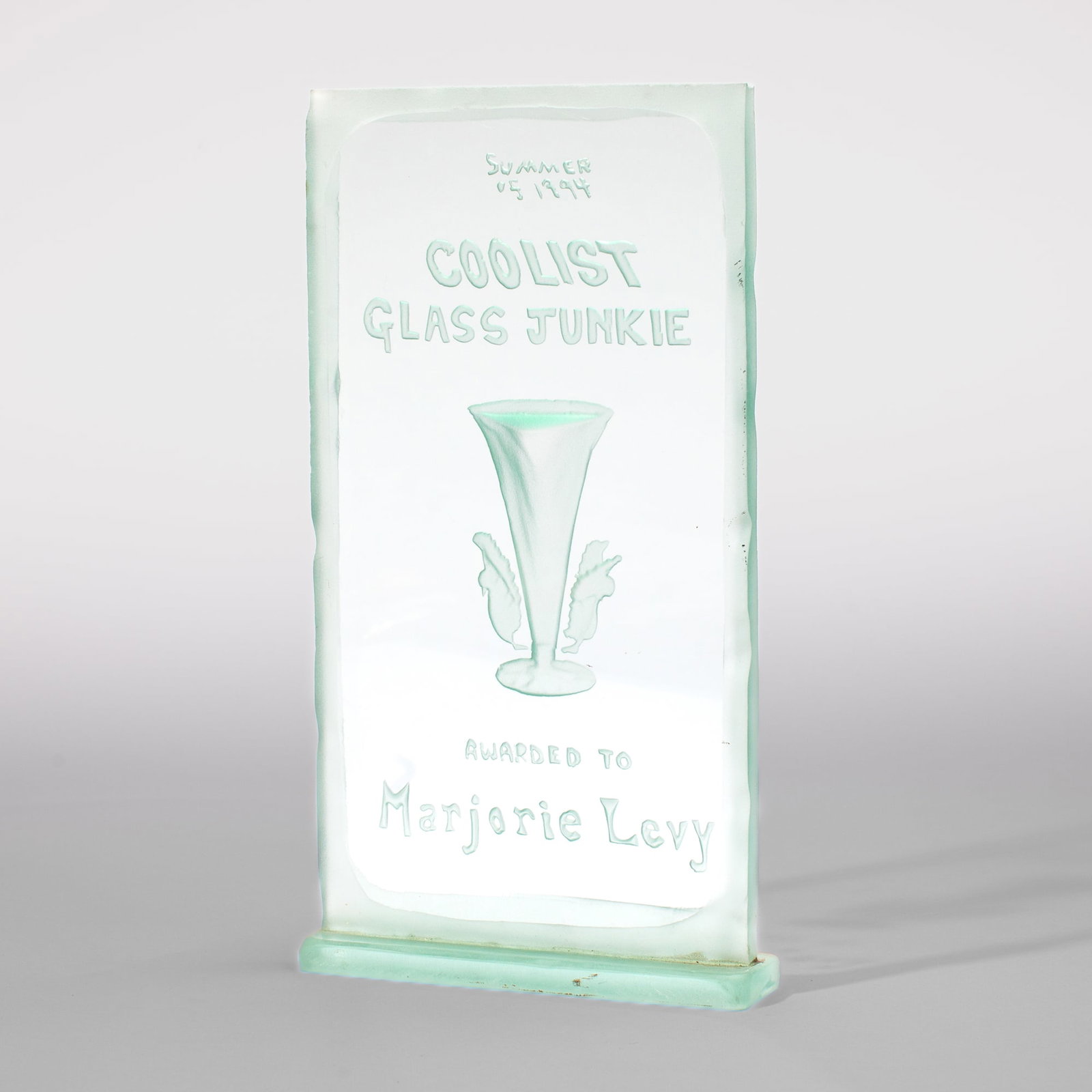 Pilchuck "Coolist Glass Junkie" Award, Summer 1994: Pilchuck "Coolist Glass Junkie" Award, Summer 1994. Carved and etched plate glass. Awarded to Marjorie Levy. Measures 12x7x1.5". Excellent condition. Collection of Marge Levy (1943-2025), former