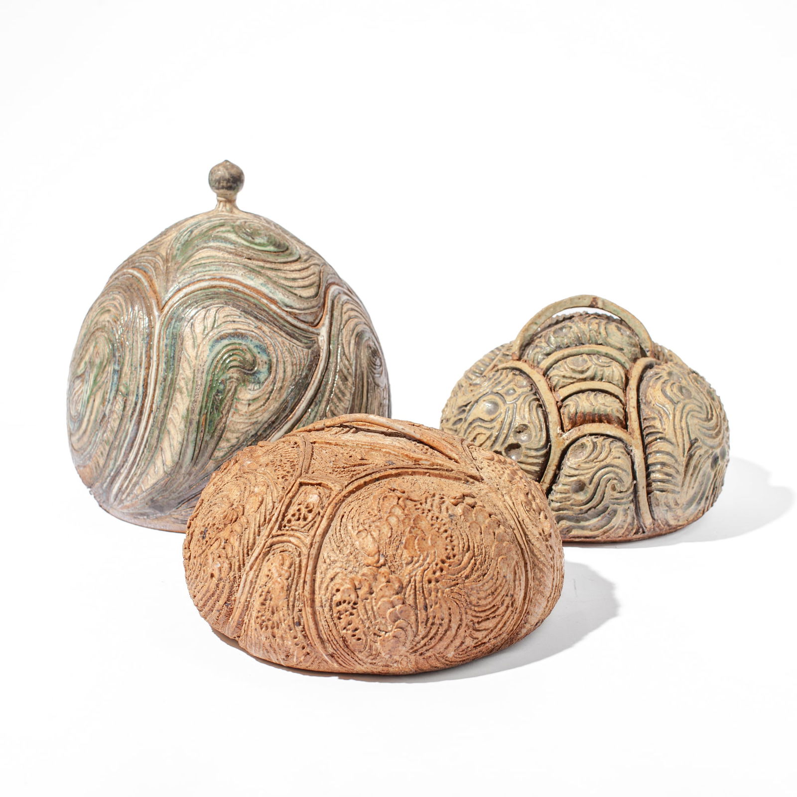 Margorie Levy (WA) Trio of Carved Lidded Pots, 70s: Margorie Levy (1943-2025 Washington) Trio of Carved Lidded Pots, 1970's. Signed on bases, dated 73-77. Pots measure 6x10", 7x9", and 11x10". Shortest pot has a couple of small chips, otherwise