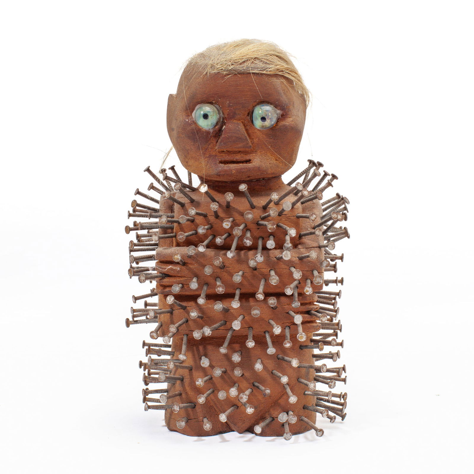 Jason Pfohl "Nkisi Nkondi" Figurine: Jason Pfohl (Mexico) "Nkisi Nkondi" Figurine, 1996. Signed and dated on base. Carved wood figure with applied glass eyes and hair; body is covered win nails hammered into wood. Measures 7.5x4.5x3". Go