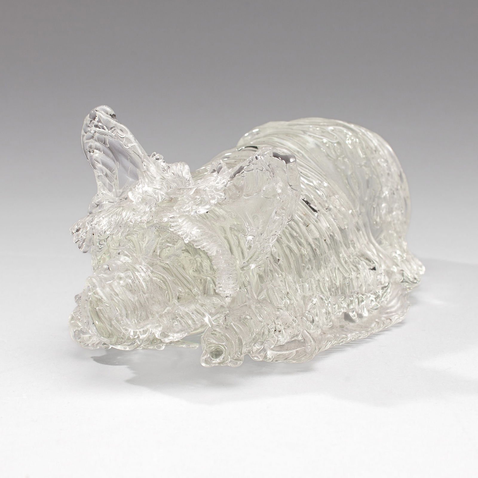 Art Glass Westie Terrier Sculpture: Art Glass Westie Terrier Sculpture. Unsigned, likely made at Pilchuck Glass School. Measures 4.5x10x6". Item has been keep outdoors for many years and has some dirt and residue in openings; otherwise