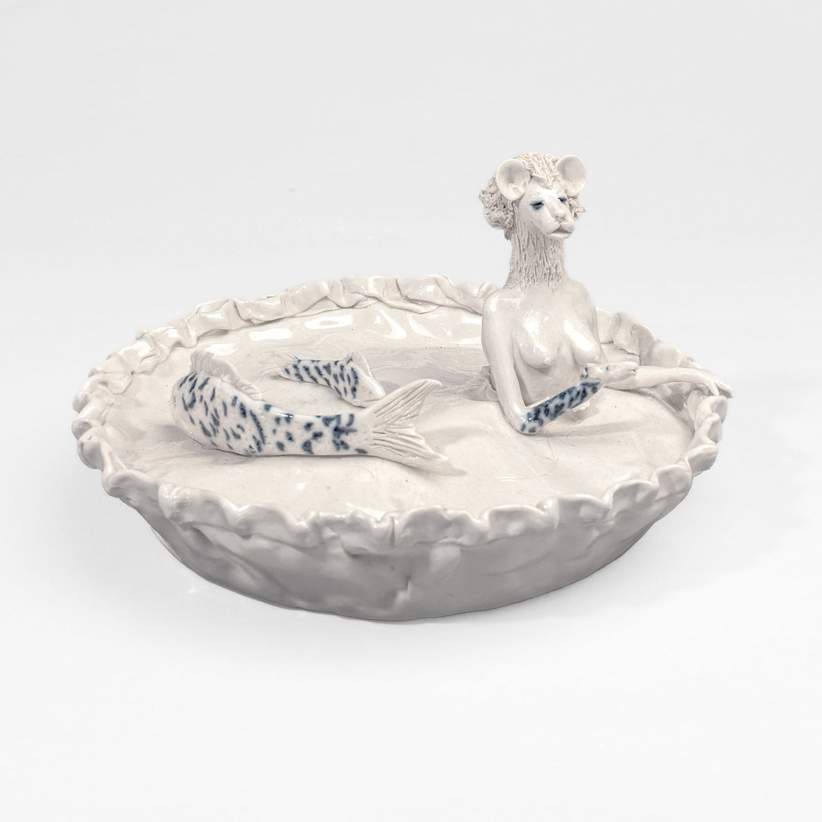 Coille Hooven "Underworld" Porcelain Sculpture: Coille Hooven (1939-2024 California) "Underworld" Porcelain Sculpture, 1987. Signed and dated on base. Depicts a lion headed character popping out from a pie wiith fish swimming on top; cobalt undergl