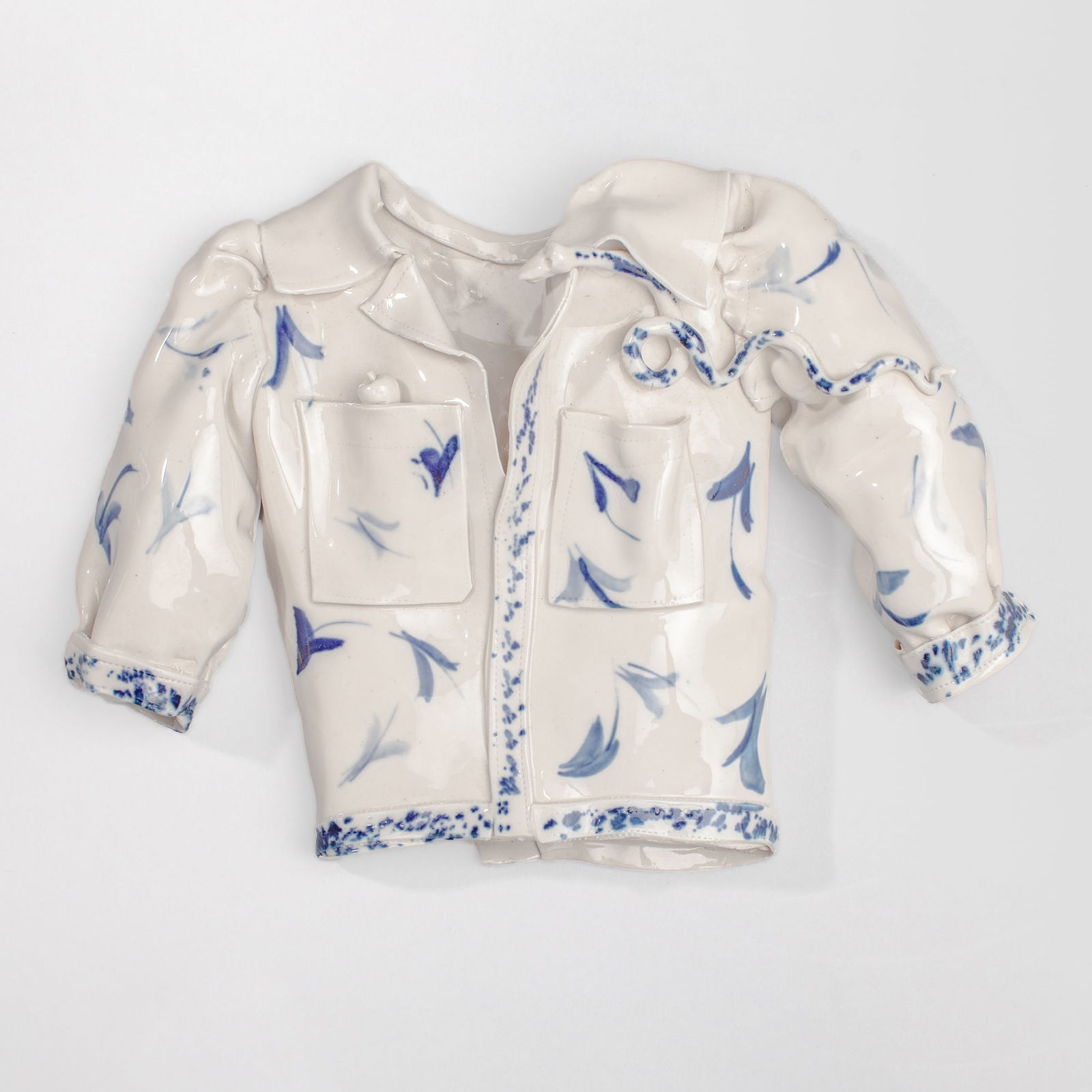 Coille Hooven "Looking for Eve" Porcelain: Coille Hooven (1939-2024 California) "Looking for Eve" Porcelain Sculpture, 1996. Signed and dated on back. Depicts botton down shirt with snake and apple; cobalt underglaze decoration. Measures 10x14