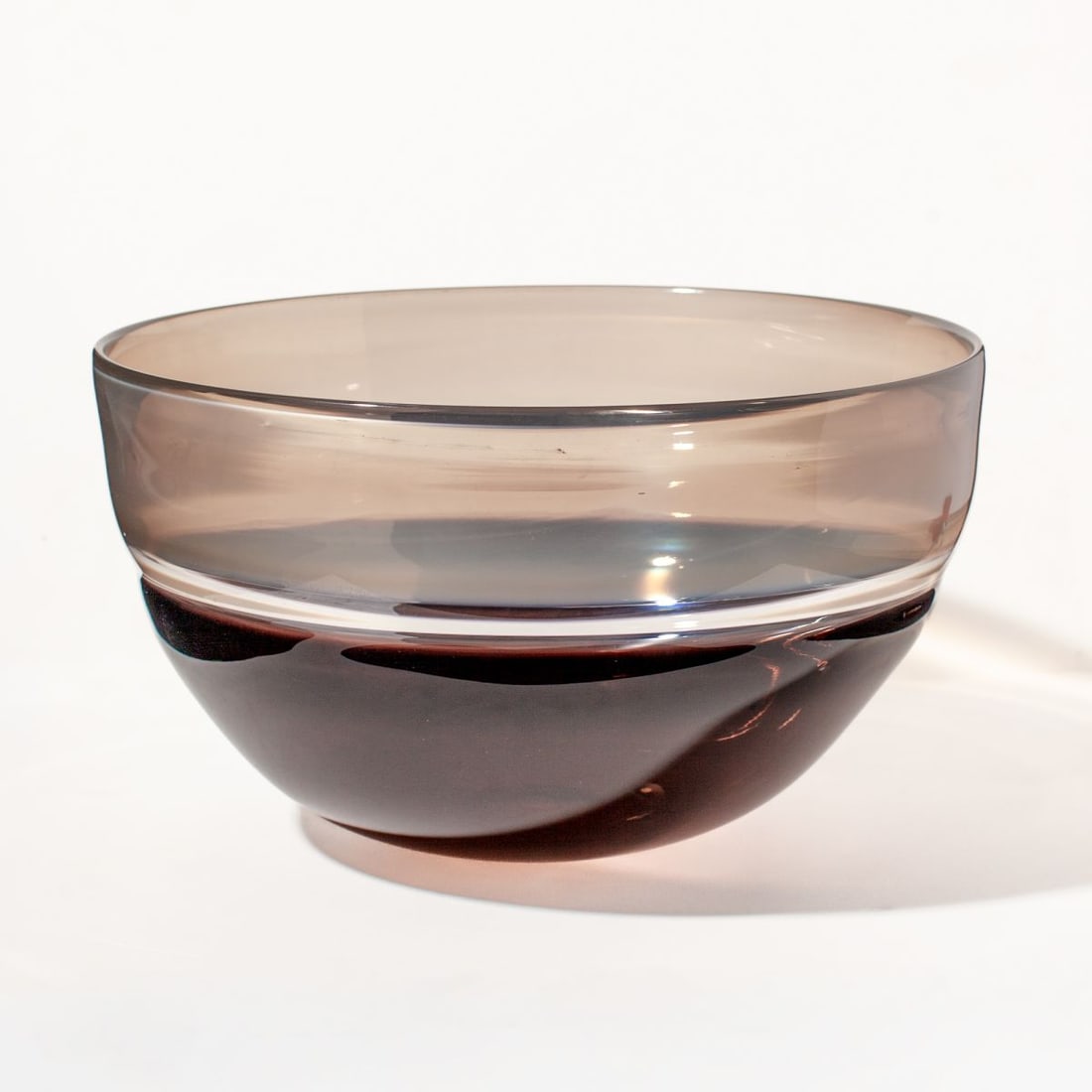 Sonja Blomdahl Incalmo Glass Bowl: Sonja Blomdahl (b. 1952 Sweden) blown incalmo glass bowl in smoky quartz and pale blue-white. Unsigned. Some light scratches to base and surface; in very good overall condition. 7" H x 12" D.