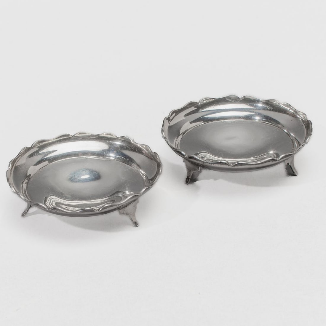 Sterling Silver Nut Dishes / NAPPER & DAVENPORT: Pair sterling silver nut dishes with hallmarks for Napper & Davenport, Birmingham; date letters for 1920 and 1921. Small crease at one foot connection of one dish; otherwise good condition. 50 total g