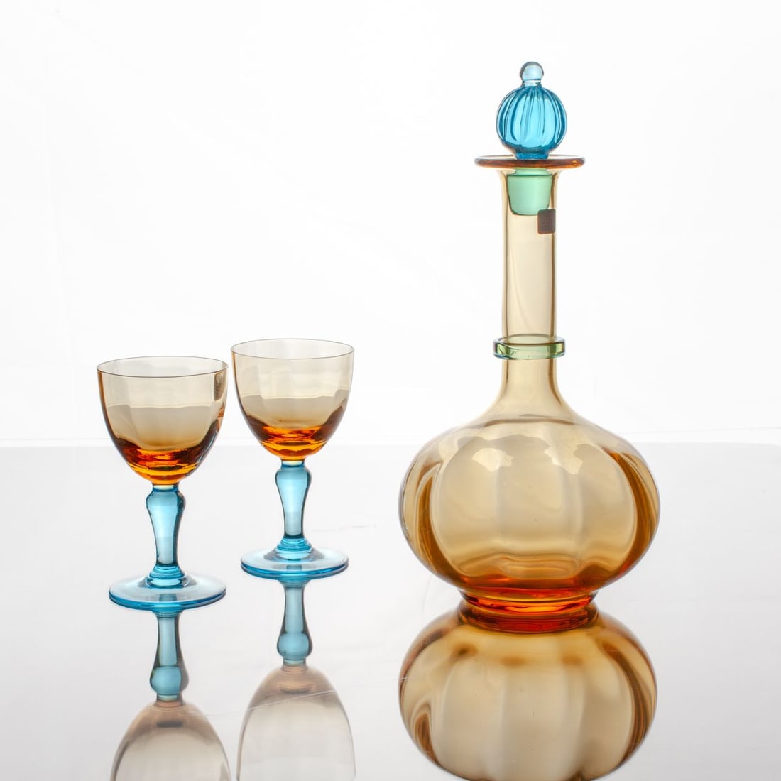 George Sand Glass Decanter Set / La Rochère: French hand blown decanter and pair goblets in amber and blue glass from La Rochère's Romatique series for Paris Musees. Acid etched marks to decanter's polished pontil along with original foil label