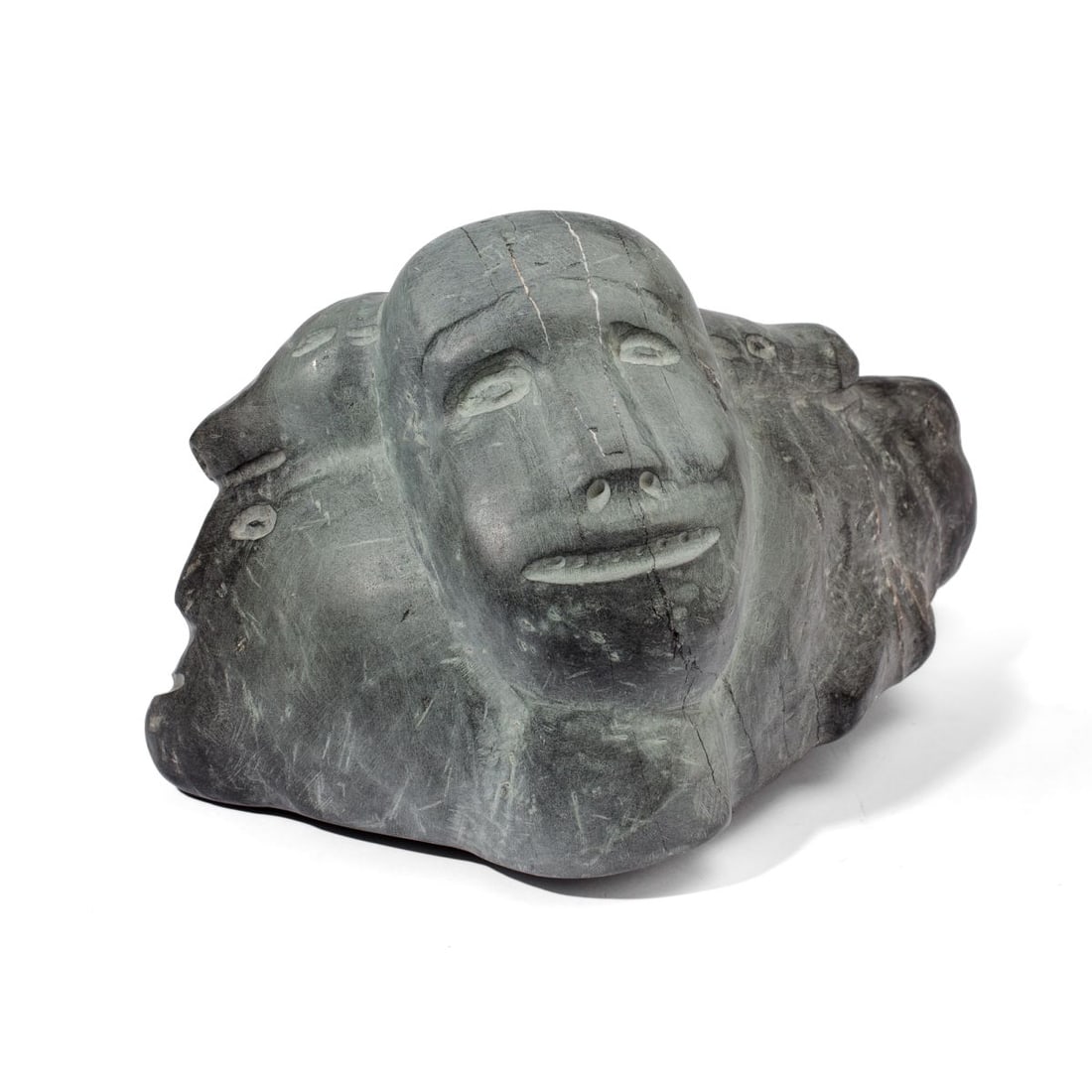 Attrib. Marie Kuunnuaq Abstract Stone Sculpture: Attributed to Marie Kuunnuaq (1933 - 1990 Baker Lake) abstracted grey stone sculpture depicting human and bear faces. Unsigned. In very good condition. 7" H x 11" L x 4.5".