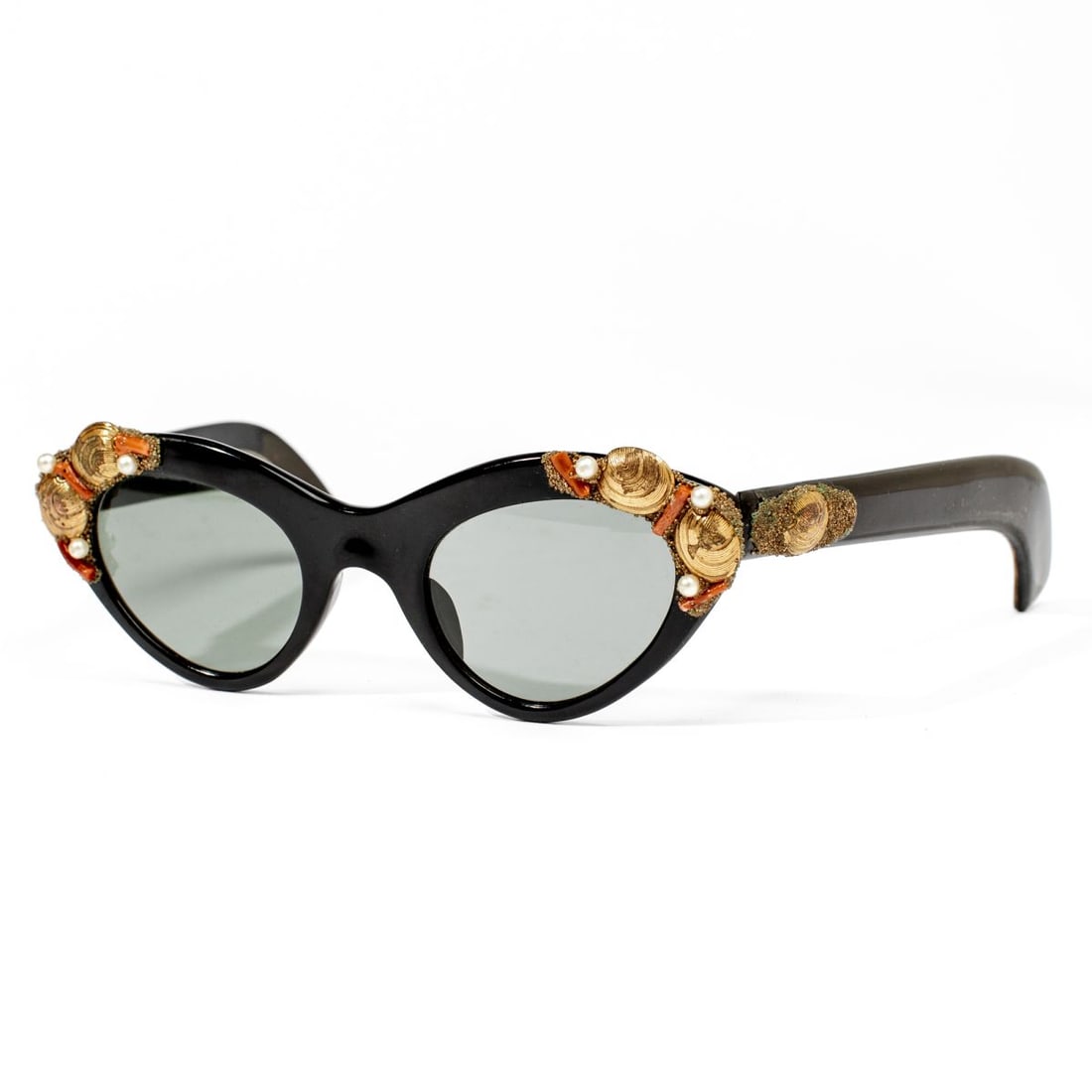 A.A Sutain France Sunglasses / Seashells & Coral: Vintage A.A Sutain black frame "Cat-Eye" style sunglasses decorated with applied gold metal seashells, faux coral pieces, and faux pearls. A.A SUTAIN marked disk. Very good condition with signs of exp