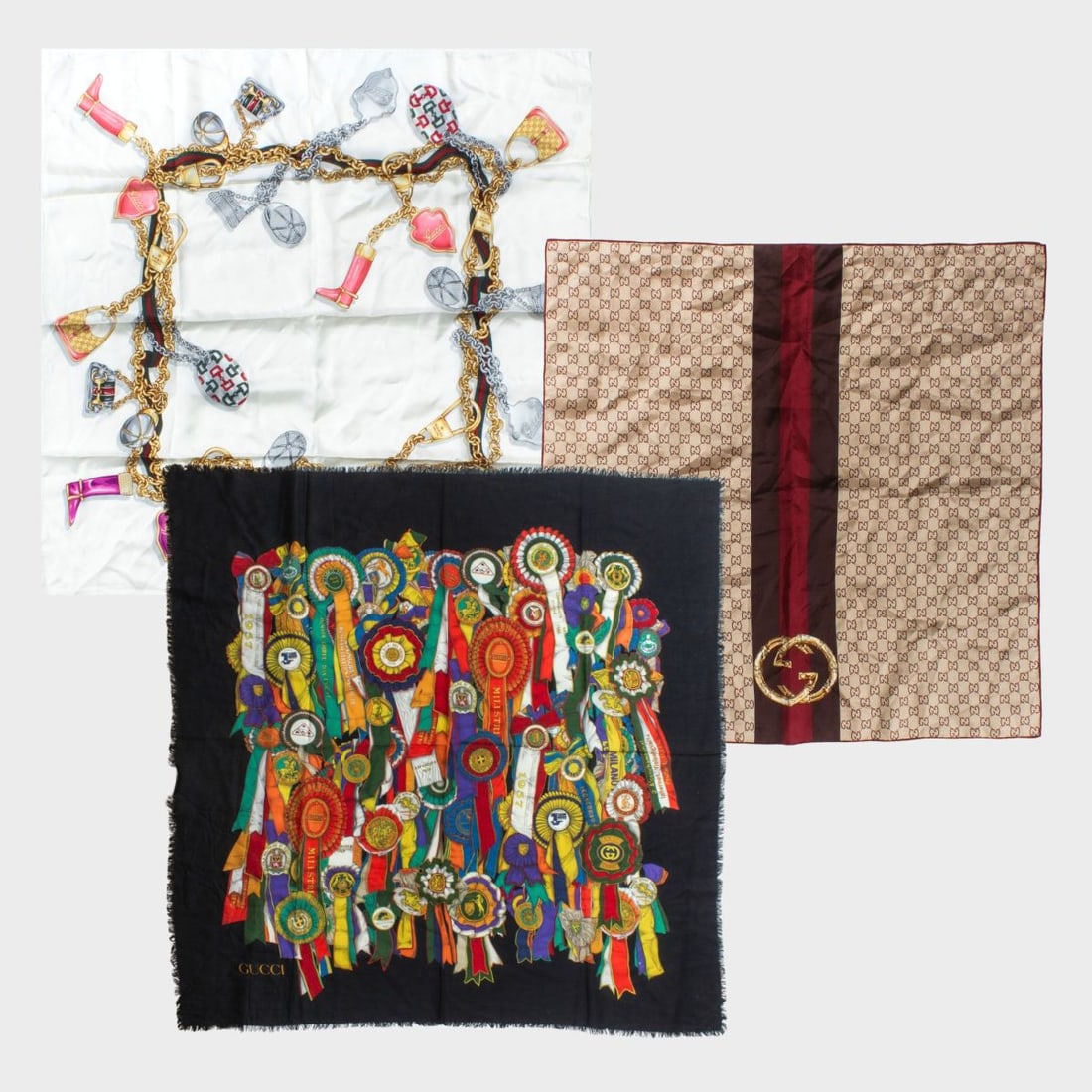 Gucci Silk & Wool Scarves: Group of 3 Gucci scarves. (1) Charm design on cream. Small pin hole to one corner. 33" x 34" approx. (2) Classic GG logo scarf with hand rolled and stictched edges. Very good condition. 26" x 26"