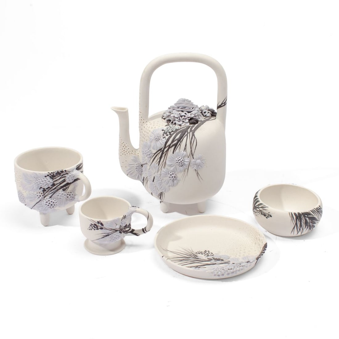 Galina Rein Pate-Sur-Pate Floral Tea set: Constructed five-piece tea set by ceramic artist Galina Rein (Russia / Seattle) consisting of teapot, two mugs, saucer and bowl each having painted glaze and intricate pate-sur-pate work. Painted