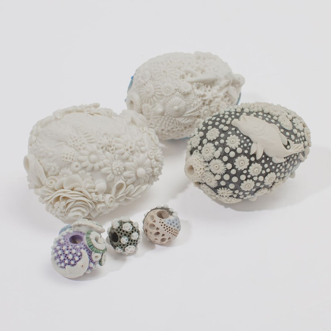 Three Pate-Sur-Pate Bottles by Galina Rein: Three ceramic bottles and beads by Galina Rein, with applied flowers, fish and marine life in pate-sur-pate tecunique over white and black biscuit; all unmarked; each in very good condition.