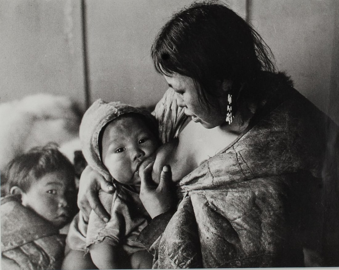 Richard Harrington Nursing Inuit Photograph: Richard Harrington (1911 - 2005 Canada) vintage silver gelatin photograph print of a nursing Inuit, reading "Padlei NWT 1950" at verso; signature and stamp. The Isaacs/Inuit Gallery label to reverse.