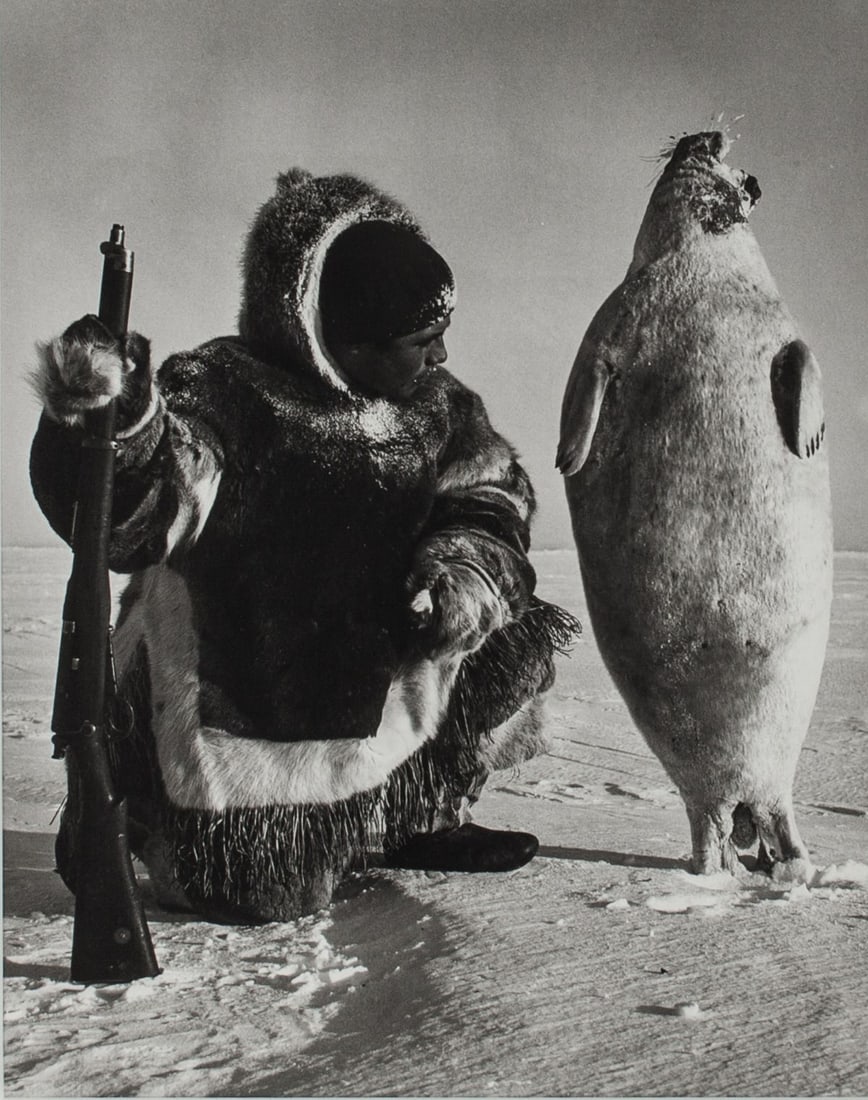 Richard Harrington "Seal Landmark" Photograph: Richard Harrington (1911 - 2005 Canada) "Kalaut with seal he just shot, quickly frozen, placed upright it serves as a landmark, to be picked up later. Igloolik 1952." Vintage silver gelatin photograph