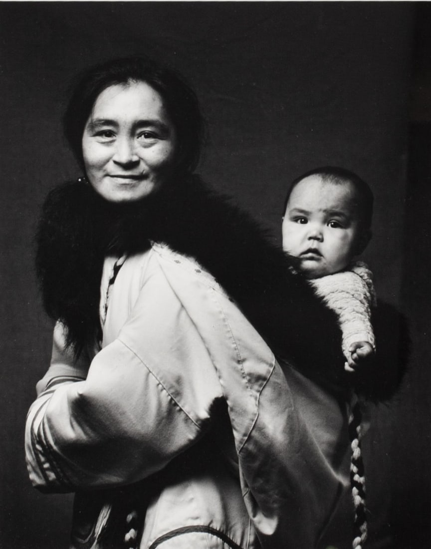 Photograph of Oviloo Tunnillie by Jerry Riley: Silver gelatin photograph of Oviloo Tunnillie with her adopted granddaughter Tye. By photographer Jerry Riley (Canada). Titled, signed and dated 1990 to mat. Framed under glass. Sight 12.5x10"; Frame