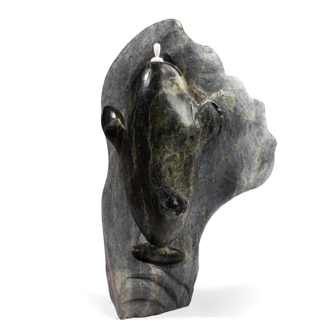 Large Inuit "Sealskin Float" Stone Sculpture: Large Inuit hand carved soapstone sculpture depicting a sealskin float (with bone nozzel) on rough-cut section carved in what appears to be a whale fin. No discernible artist signature. Some wear