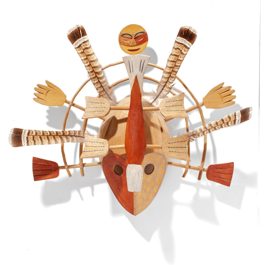 Inuit Nunivik Island Wood Inua Spirit Mask: Carved and painted wood Inuit mask depicting Inua spirit; carved face with attached arms and hands, celestial spirt, feathers, and flying fish. Inventory number written to interior. Fish has 