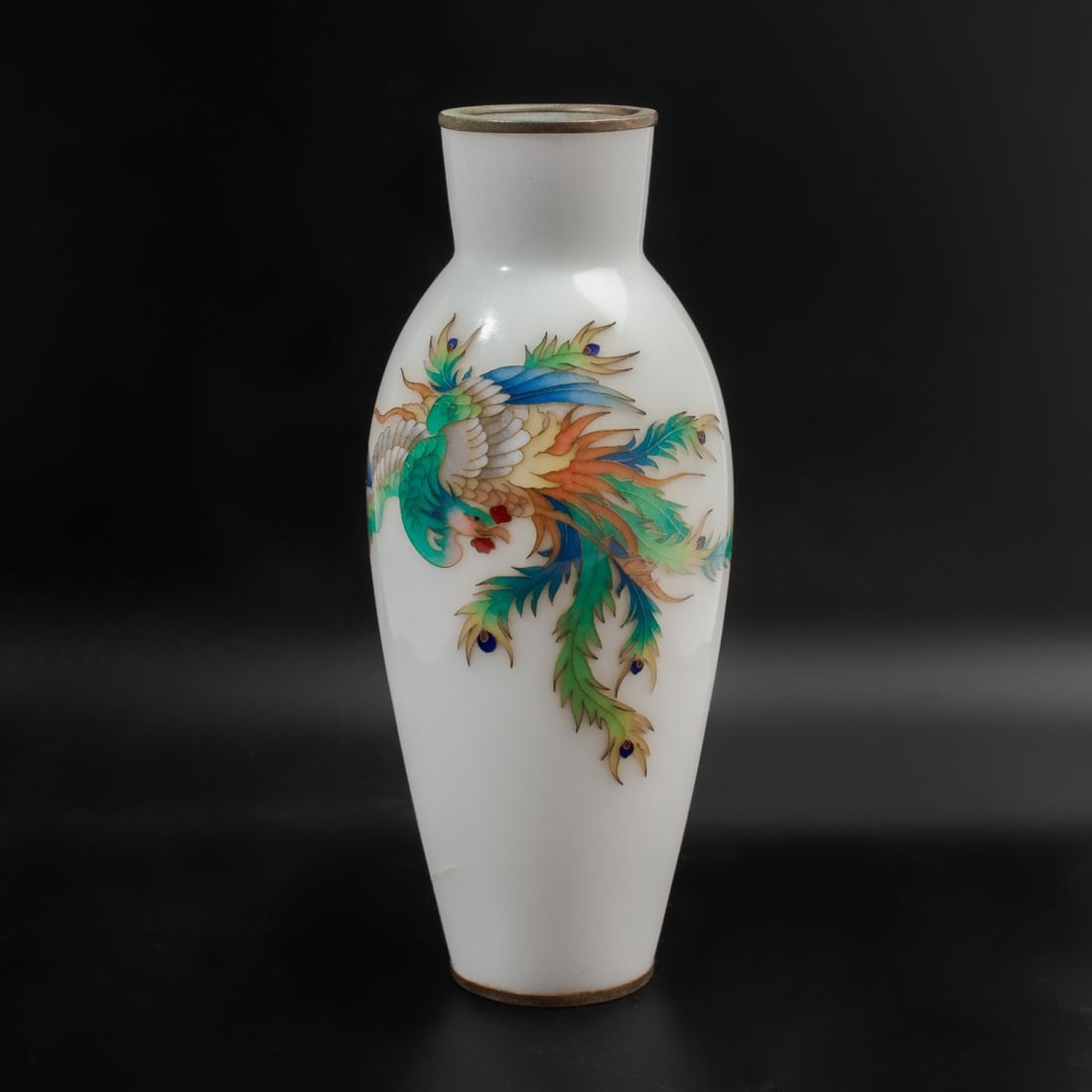 Japanese Ando Jubei "Phoenix" Cloisonne Vase: Japanese Ando Jubei Company cloisonne vase depicting phoenix in silver wire and translucent enamels over white ground. Ando Company seal to base. Cracks to enamel ground. 7" H.