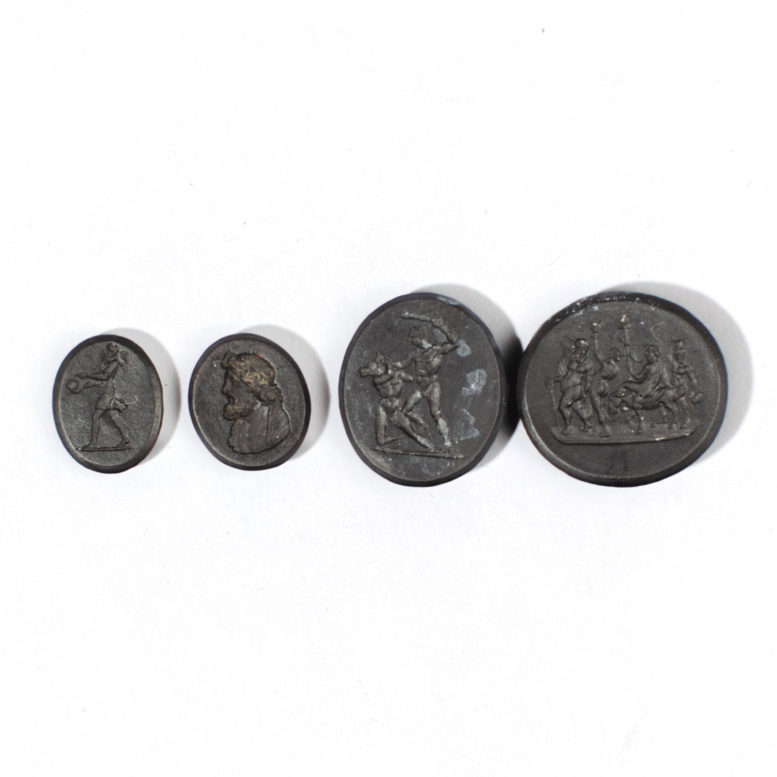 Four Wedgwood & Bentley Black Basalt Intaglio Seal: Four 18th century Wedgwood & Bentley black basalt intaglio seals. Includes depiction of Theseus or Hercules clubbing the Minotaur, a Bacchanal procession, portrait of a man facing left, and Saturn wit