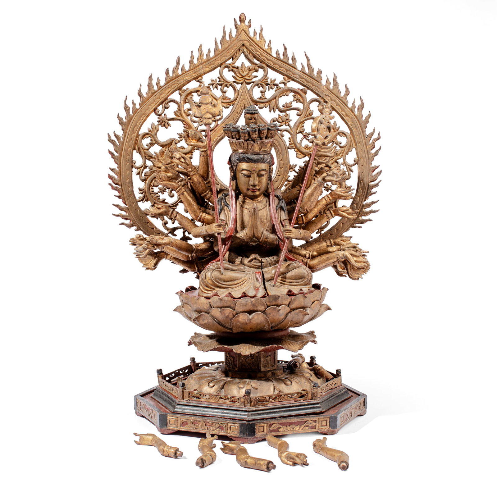 Antique Chinese Giltwood Thousand Armed Guanyin: Antique Chinese carved wood depiction of the Thousand-Arm Guanyin with hands in anjali mudra seated on a lotus petal above octagonal base with openworked gate (one piece loose), the removeable
