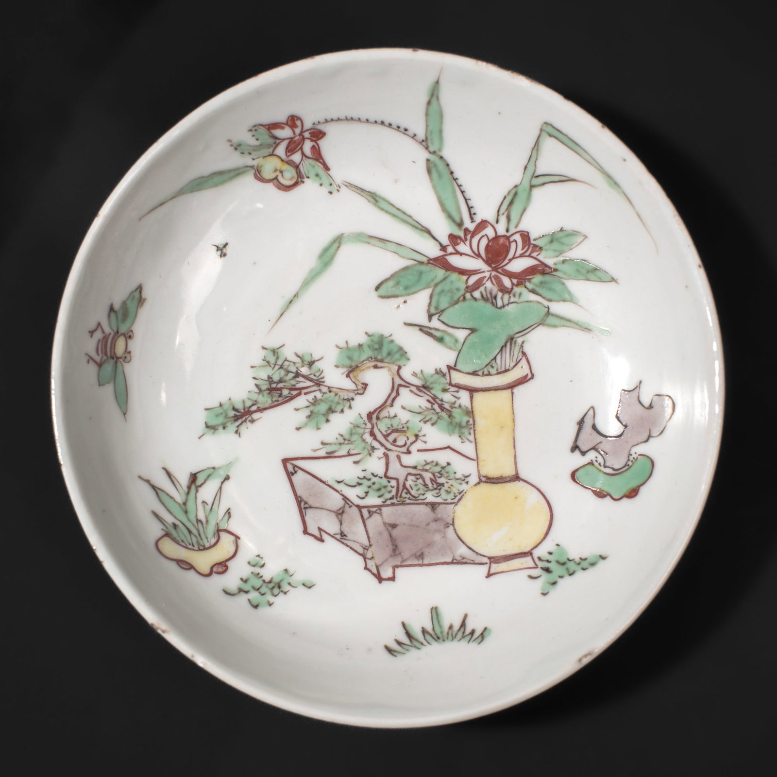 Chinese Late Ming Period Japanese Market Dish: Chinese porcelain dish made for the Japanese market. Late Ming Dynasty, Chongzhen or Tianqi periods. Outdoor scene with vase, censers, bonsai and lotus flowers in bloom. Expected light fritting and