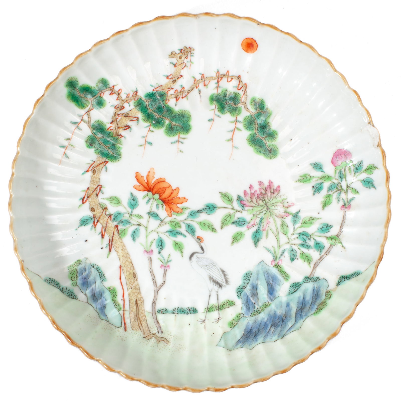 Chinese Famille Rose Porcelain Crane & Pine Dish: 18th century Chinese enameled porcelain ribbed dish depicting crane below tall chrysanthemum flowers in iron red and famille rose enamels; the branches of an old gnarled pine tree reaching towards the