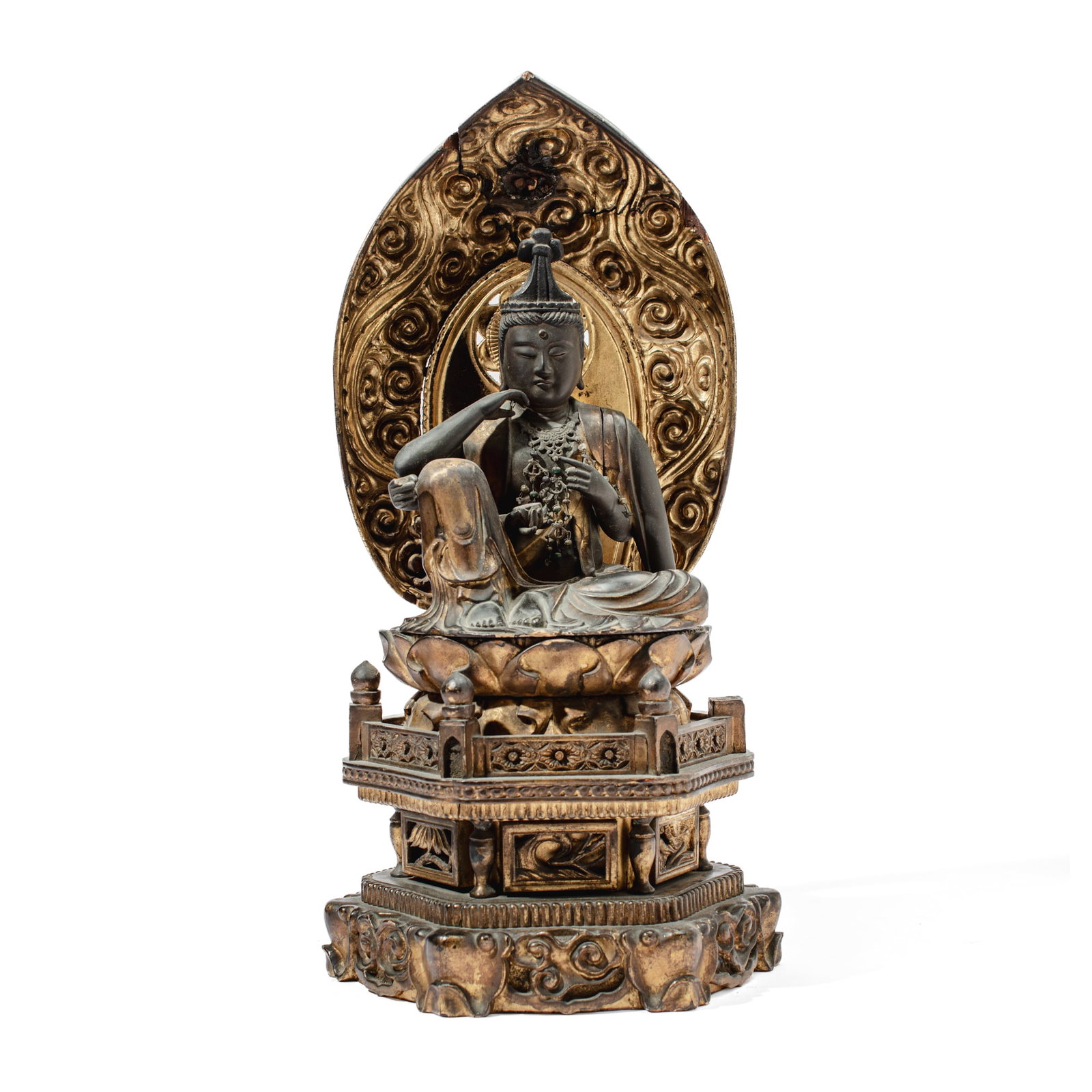 Japanese Edo Period Nyoirin Kannon Buddhist Wood Sculpture: Japanese wood sculpture depicting Nyoirin Kannon seated on lotus pedestal base with cloud-form mandorla; the base comprised of cloud feet below openwork panels of pine, prunus and banana leaves with w