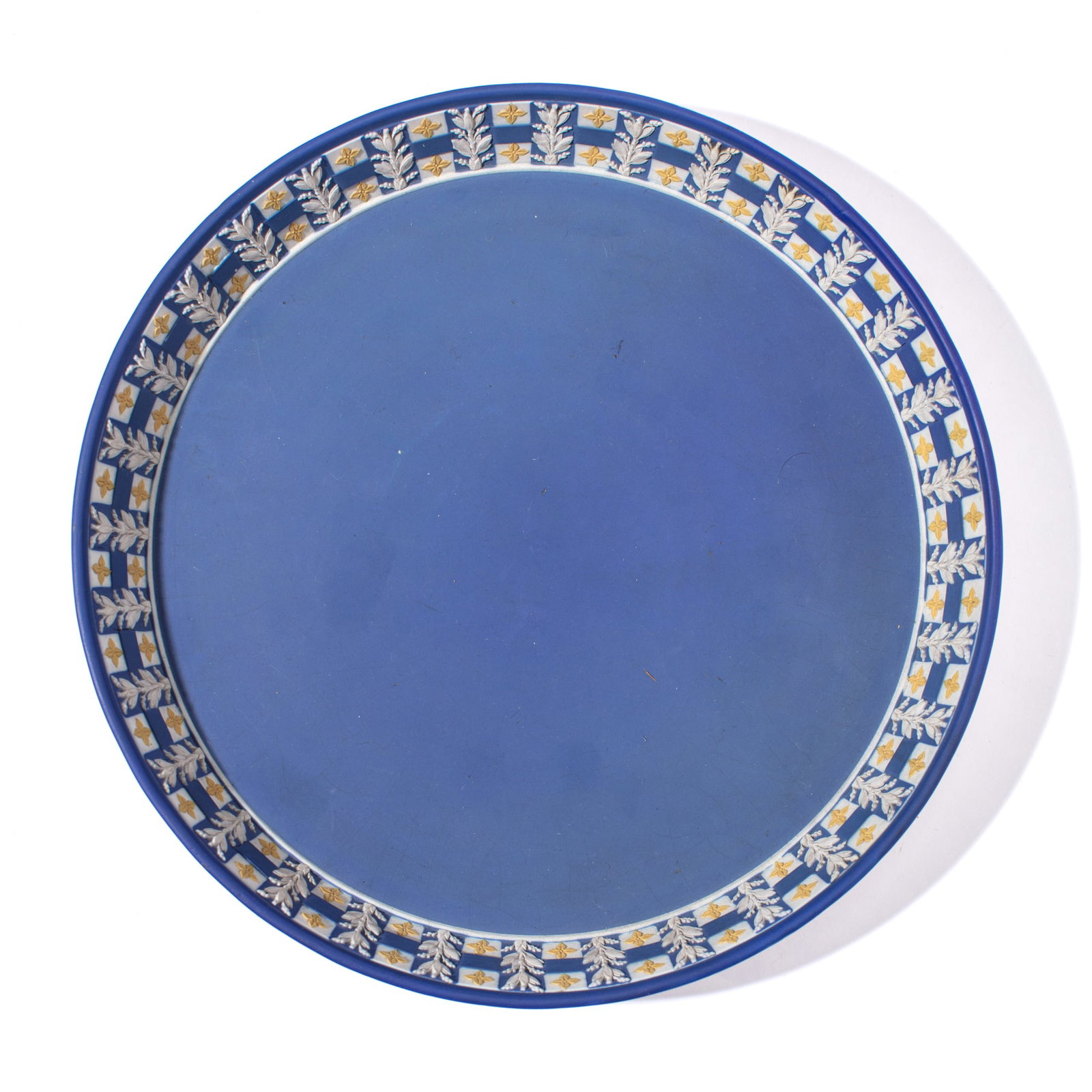 Wedgwood Tricolor Jasperware Circular Tray: 19th century Wedgwood tricolor jasperware in blue, white and cane yellow; diced cavetto between alternating laurel sprigs. Impressed "WEDGWOOD" mark to underside. Very slight losses to blue dip at int
