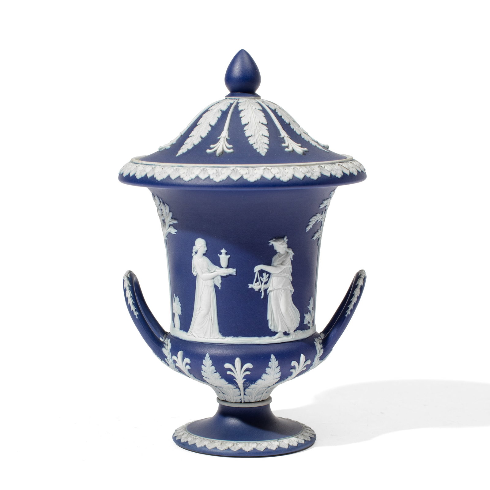 Wedgwood Dark Blue Jasperware Covered Urn: Late 19th century Wedgwood mazarine blue jasperware covered urn with classical maidens above acanthus leaves and handles. Impressed "WEDGWOOD" and "ENGLAND" marks to underside. In very good condition.